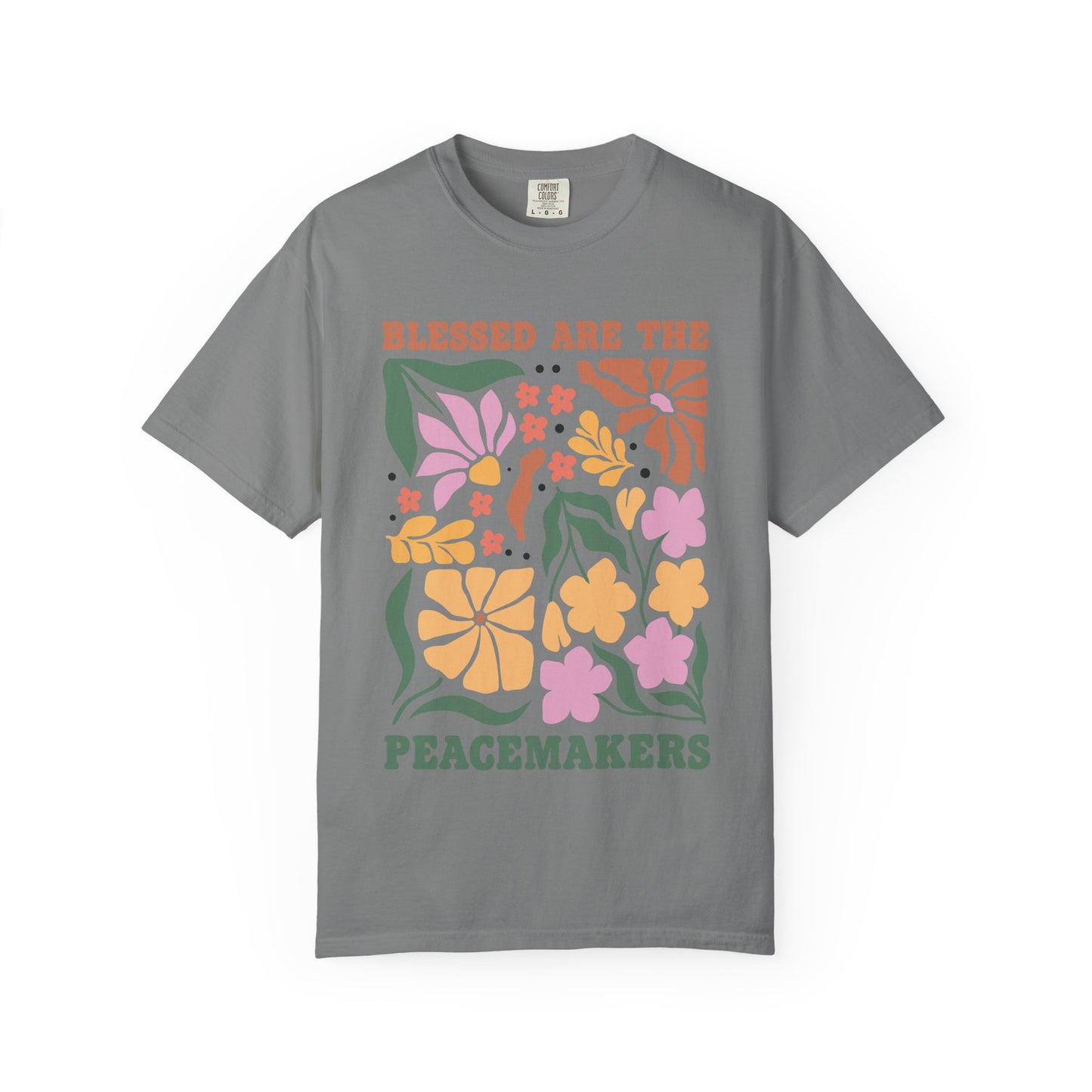 T-shirt with 'Blessed Are The Peacemakers' text surrounded by colorful floral design in pink, coral, yellow and green