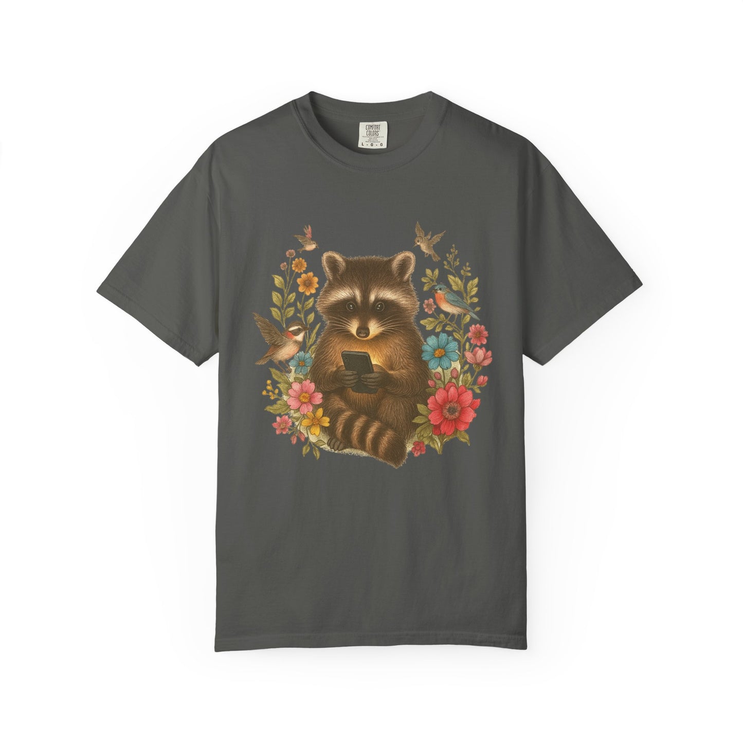 T-shirt design showing raccoon holding phone surrounded by colorful wildflowers and birds