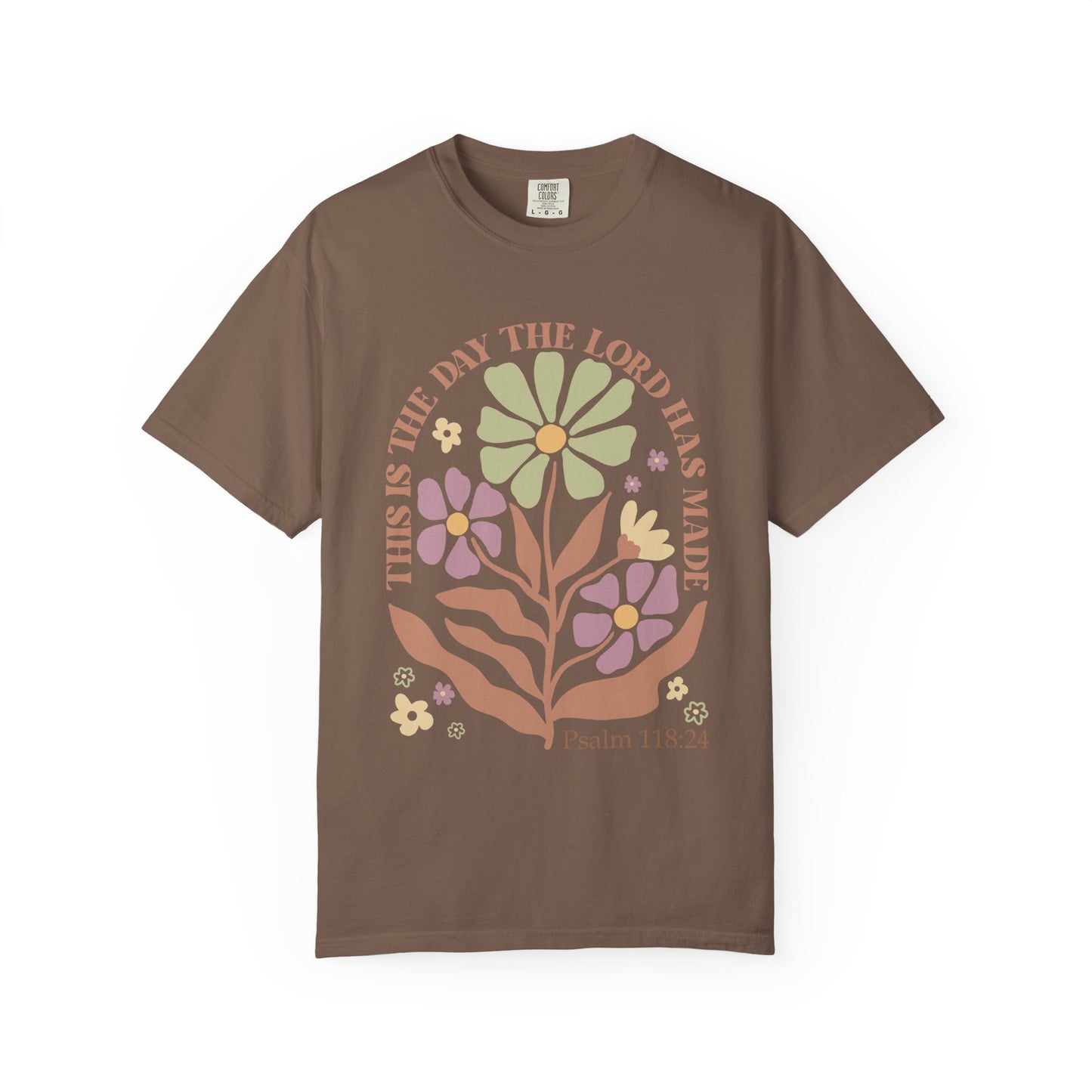T-shirt with 'This is the Day' text, Psalm 118:24 verse, and floral design with protective hands in sage green, pink, and terracotta colors