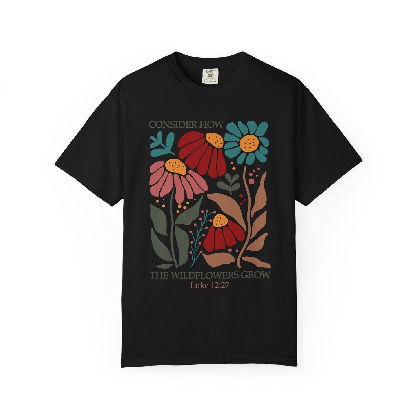 T-shirt with Luke 12:27 Bible verse and colorful wildflowers in red, pink, teal, and brown tones
