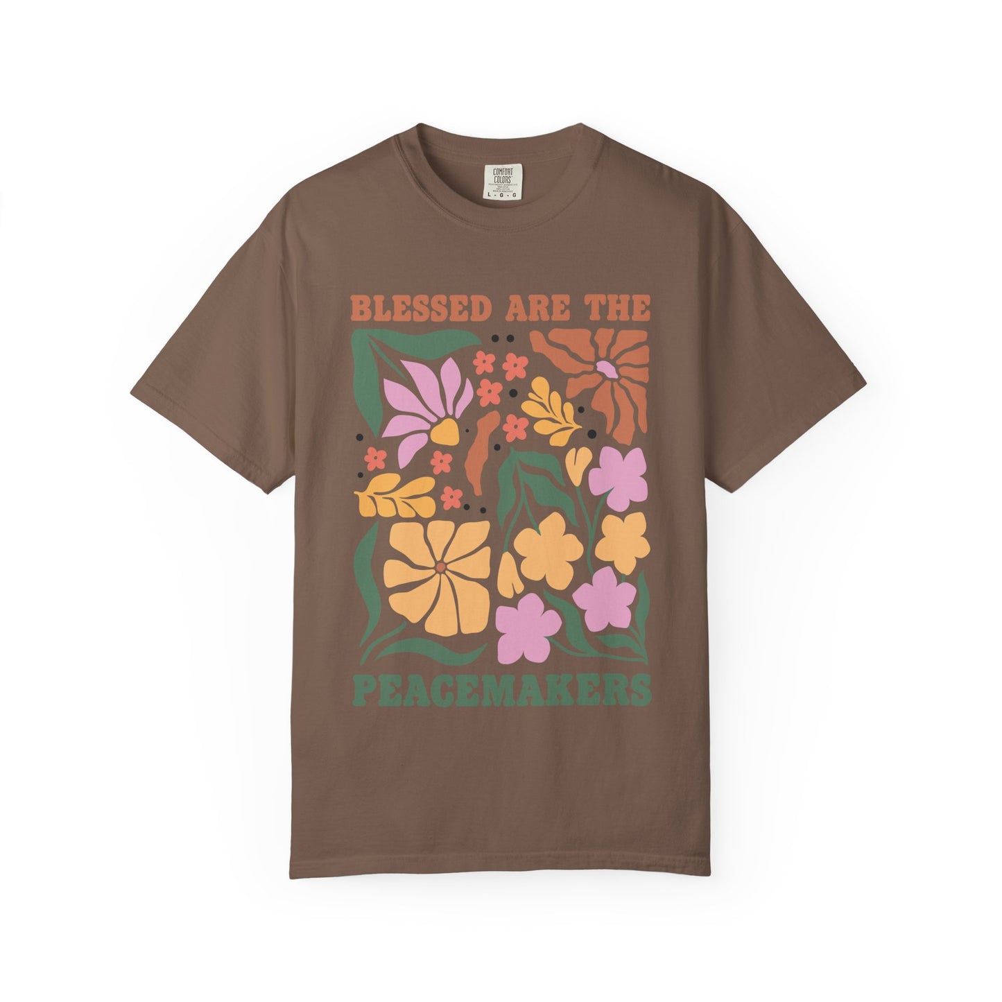 T-shirt with 'Blessed Are The Peacemakers' text surrounded by colorful floral design in pink, coral, yellow and green