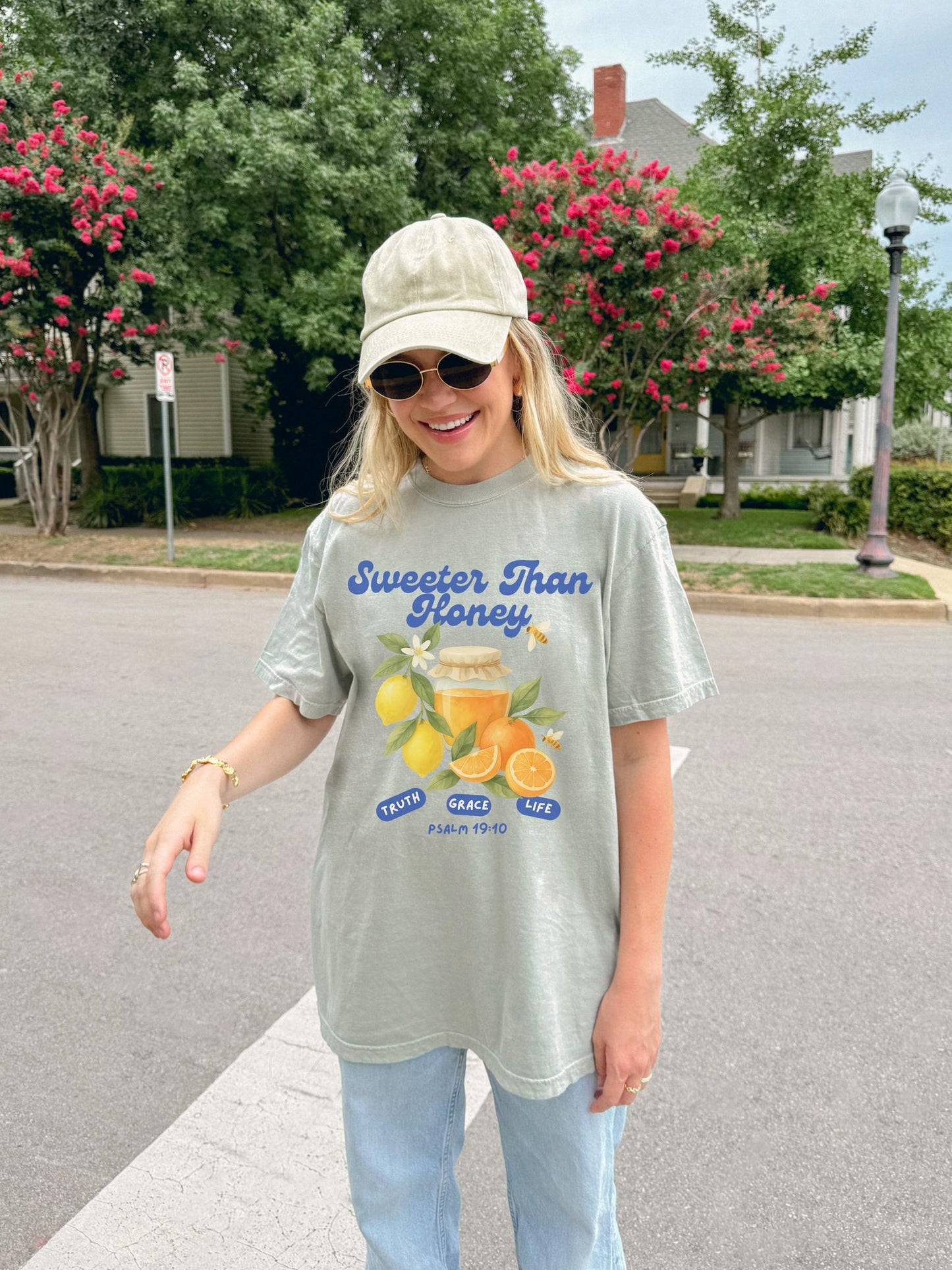 Christian t-shirt with Sweeter Than Honey Psalm 19:10 design featuring watercolor honey jar, citrus fruits, and bees