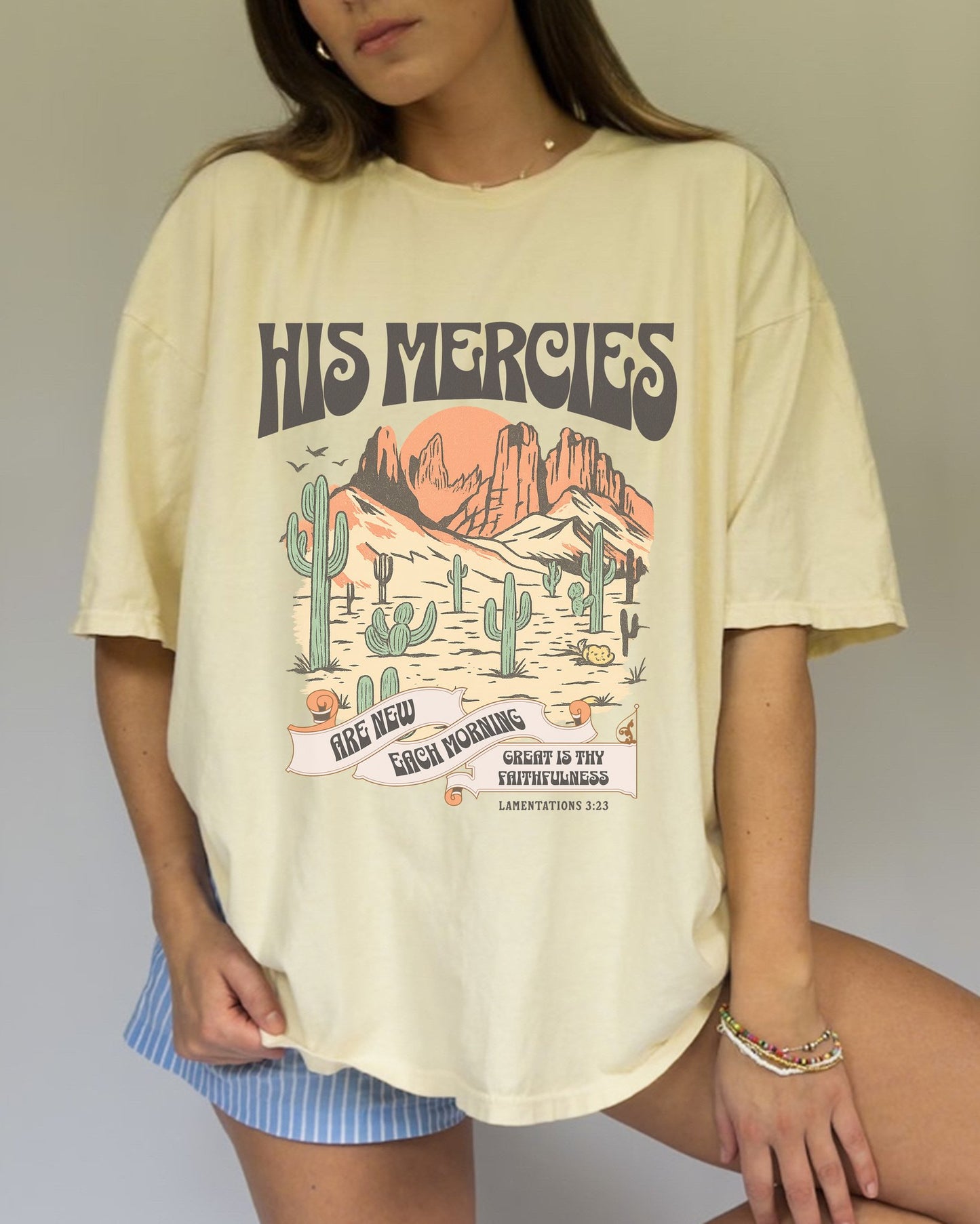 Christian t-shirt with desert landscape design featuring 'His Mercies Are New Each Morning' text and Lamentations 3:23 verse