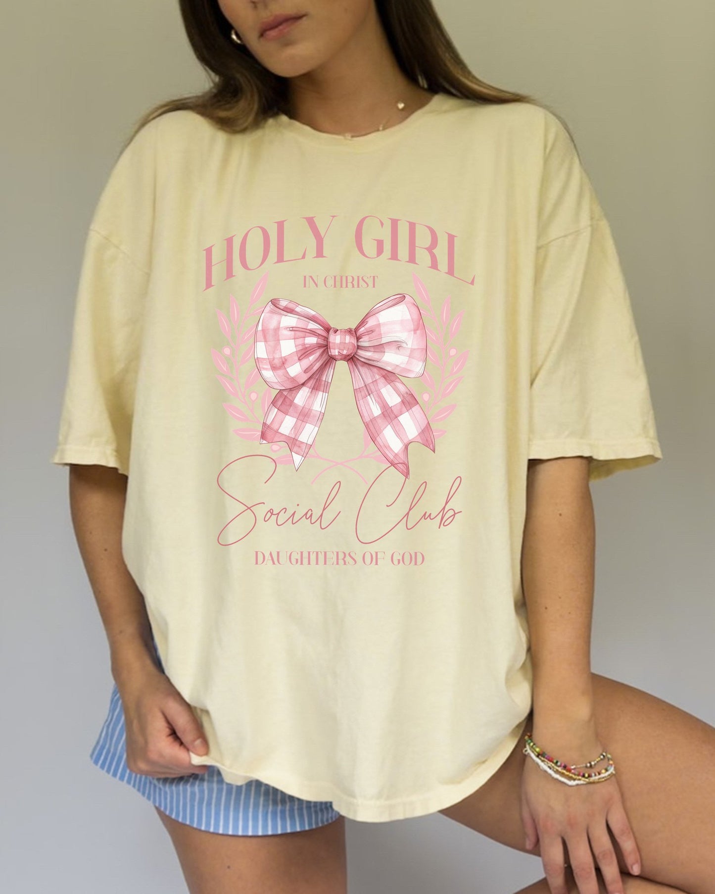 Tshirt with Holy Girl Social Club design featuring pink gingham bow and floral elements