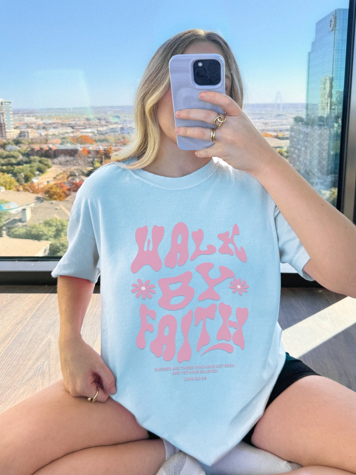 T-shirt with pink wavy font saying Walk By Faith with flowers and John 20:29 Bible verse