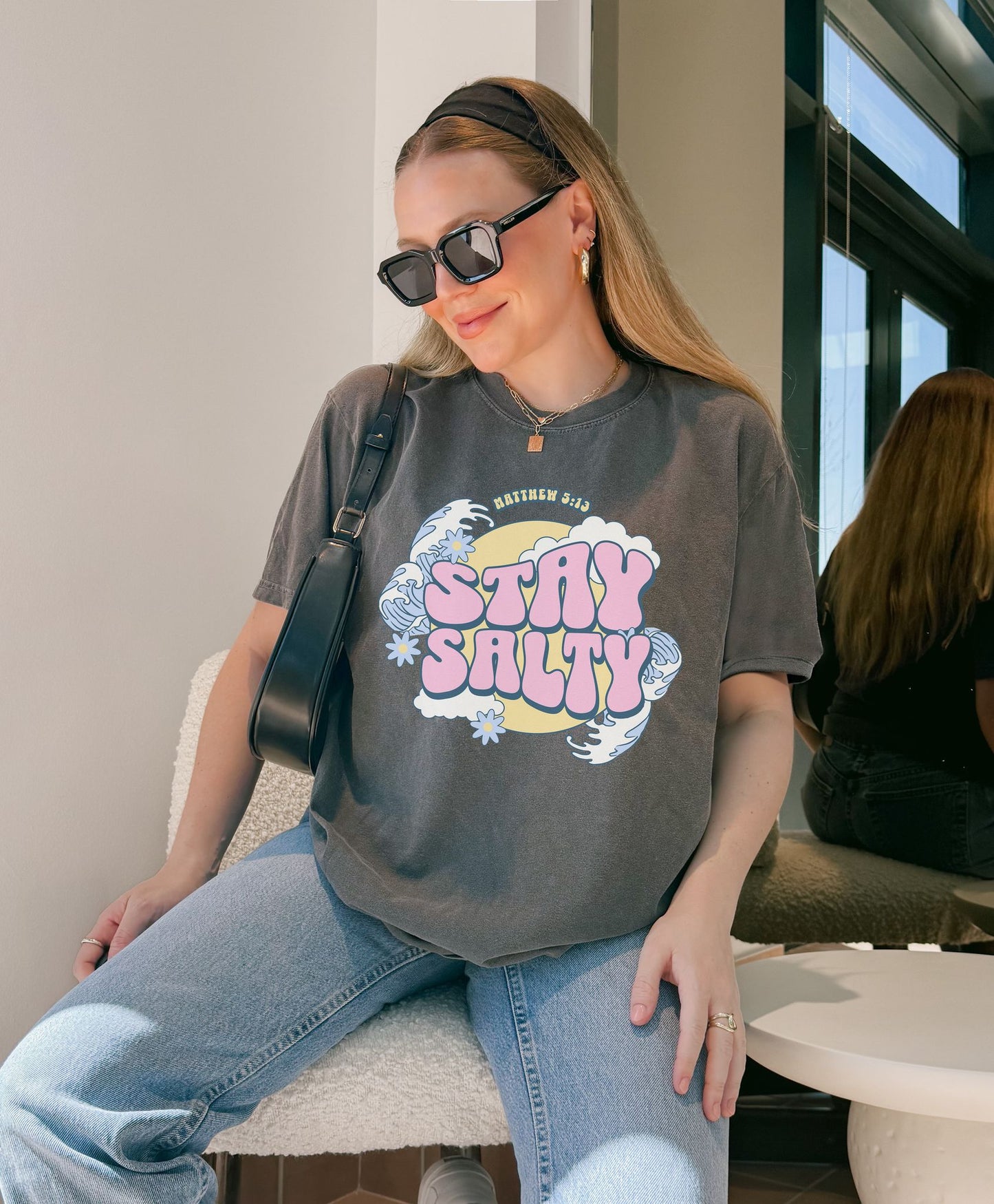 T-shirt with wavy font Stay Salty Matthew 5:13 text in pink bubble letters with ocean waves and flowers