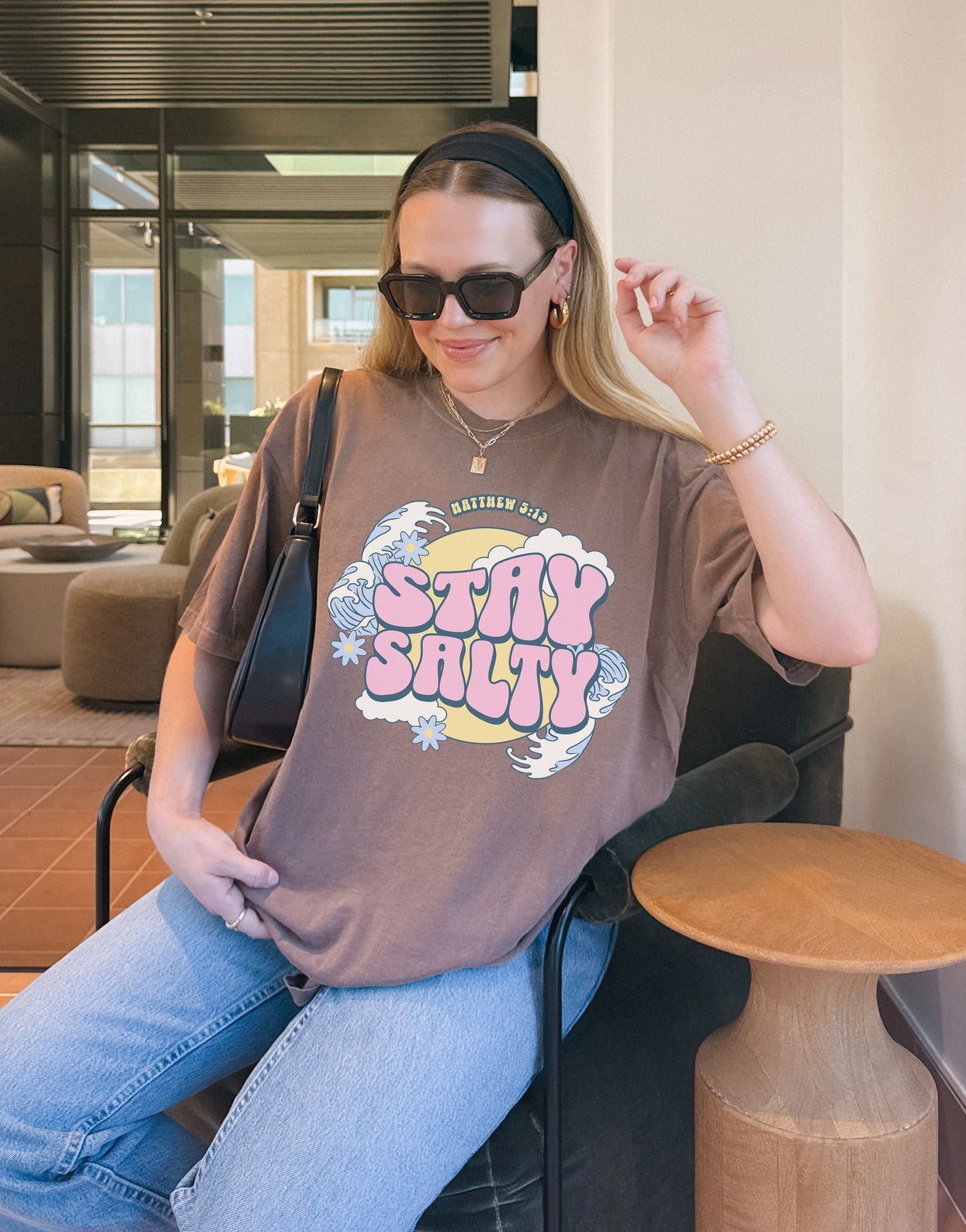 T-shirt with wavy font Stay Salty Matthew 5:13 text in pink bubble letters with ocean waves and flowers