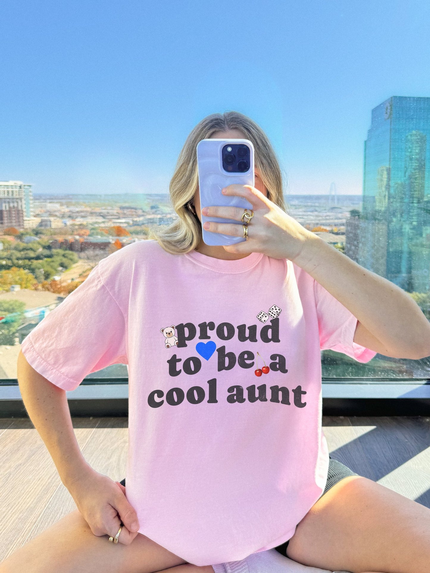 T-shirt with retro distressed text 'proud to be a cool aunt' decorated with teddy bear, blue heart, dice, and cherries