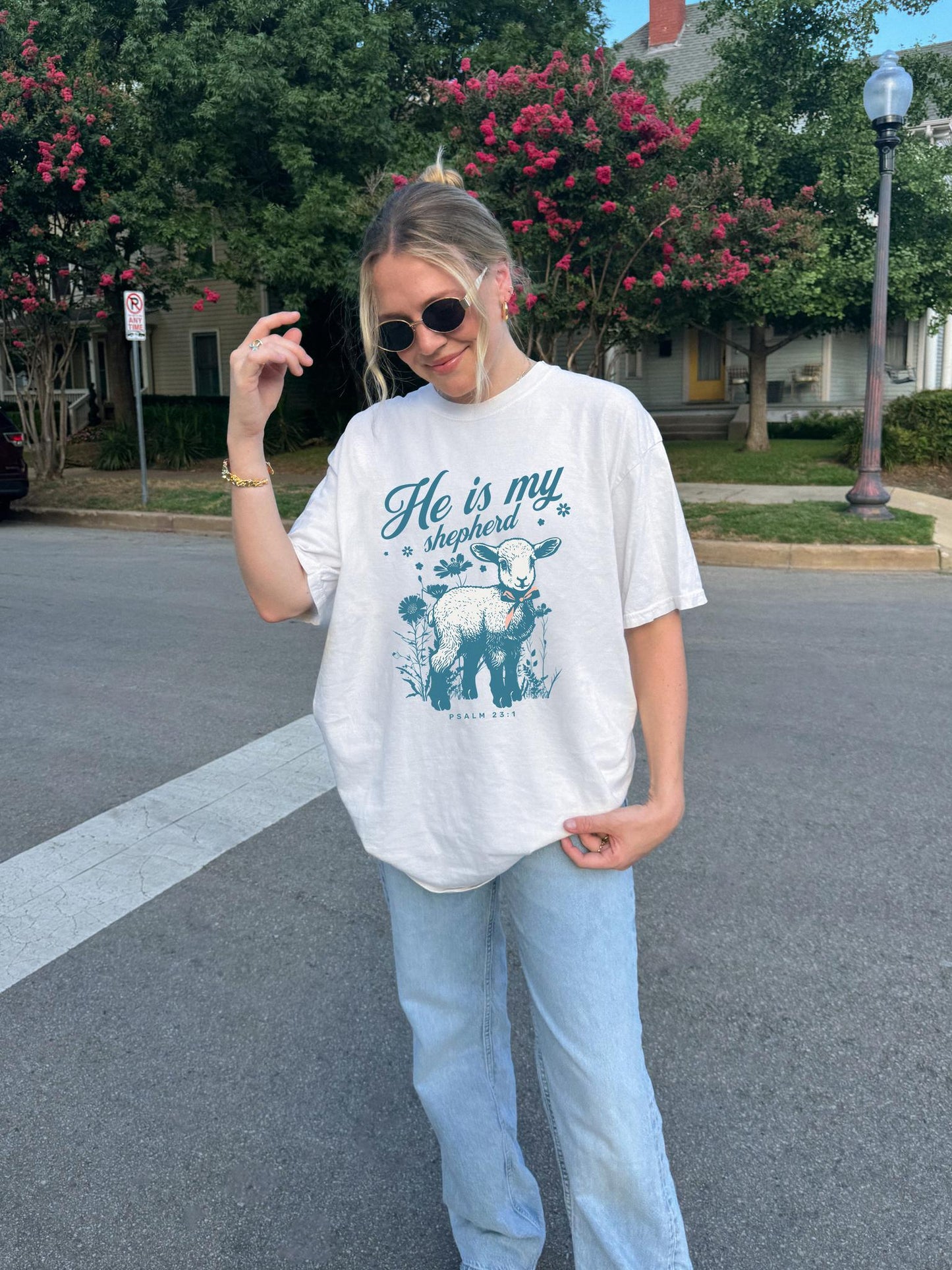 Christian t-shirt featuring adorable lamb with wildflowers and 'He Is My Shepherd' text in teal