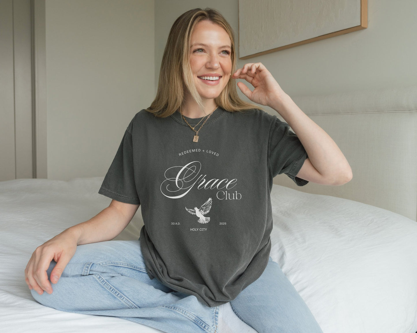 T-shirt with Grace Club text, dove symbol, and Redeemed + Loved message in elegant green design