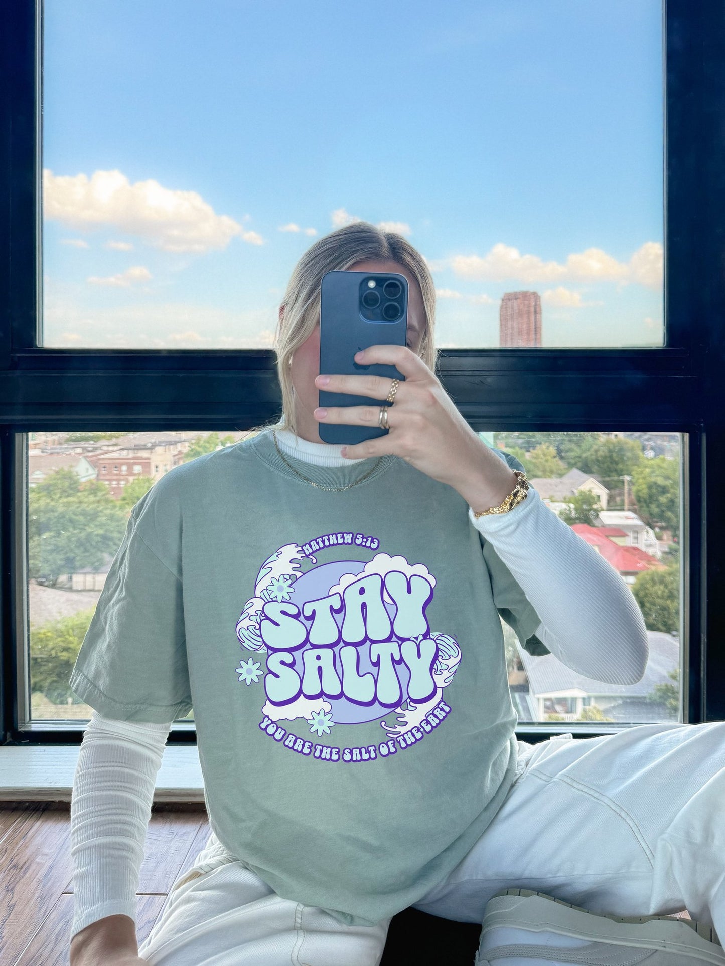 T-shirt with purple and mint green 'Stay Salty' text design featuring Matthew 5:13 scripture and retro styling