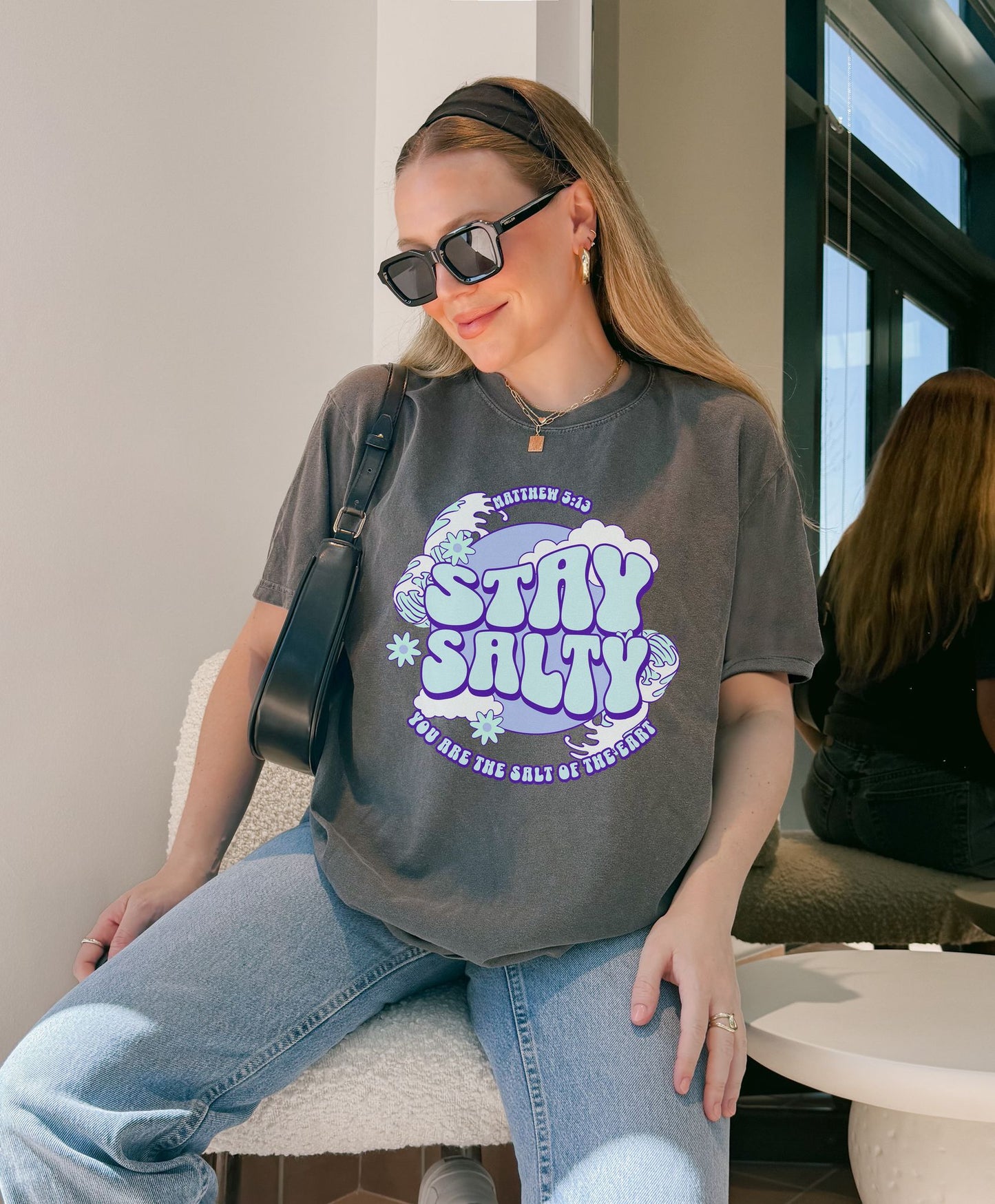 T-shirt with purple and mint green 'Stay Salty' text design featuring Matthew 5:13 scripture and retro styling