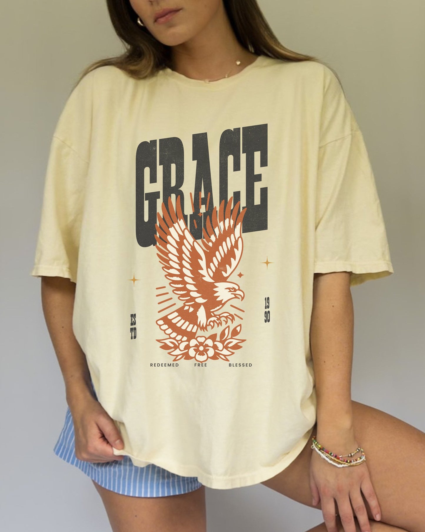 Christian t-shirt with vintage eagle design in orange and cream colors featuring Grace text and decorative elements