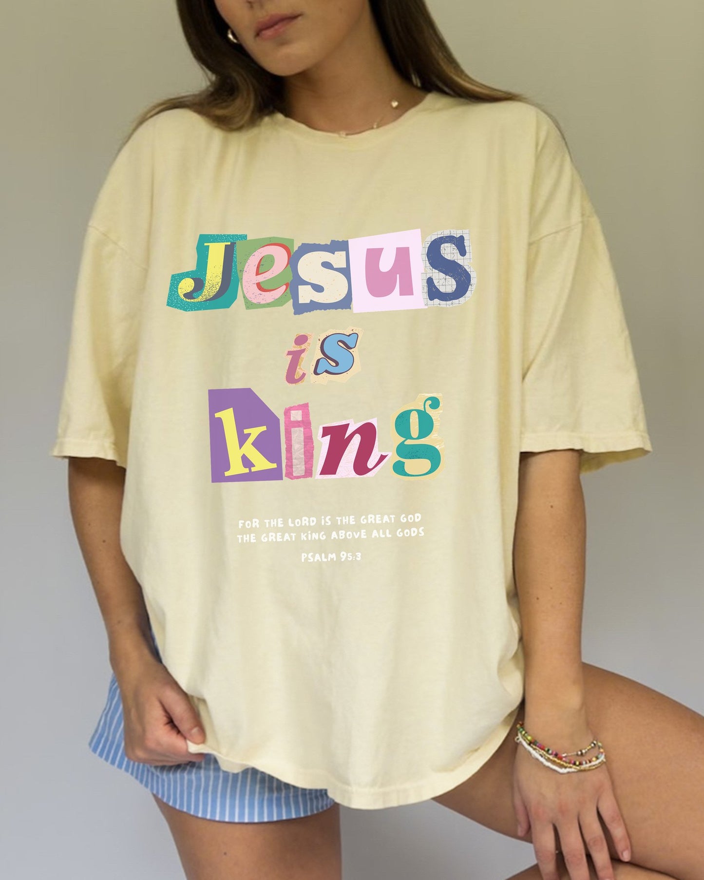 T-shirt with colorful block letters spelling Jesus is King and Psalm 95:3 Bible verse
