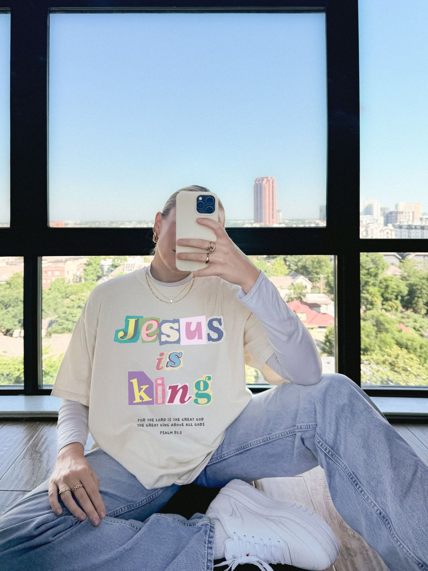 T-shirt with colorful block letters spelling Jesus is King and Psalm 95:3 Bible verse