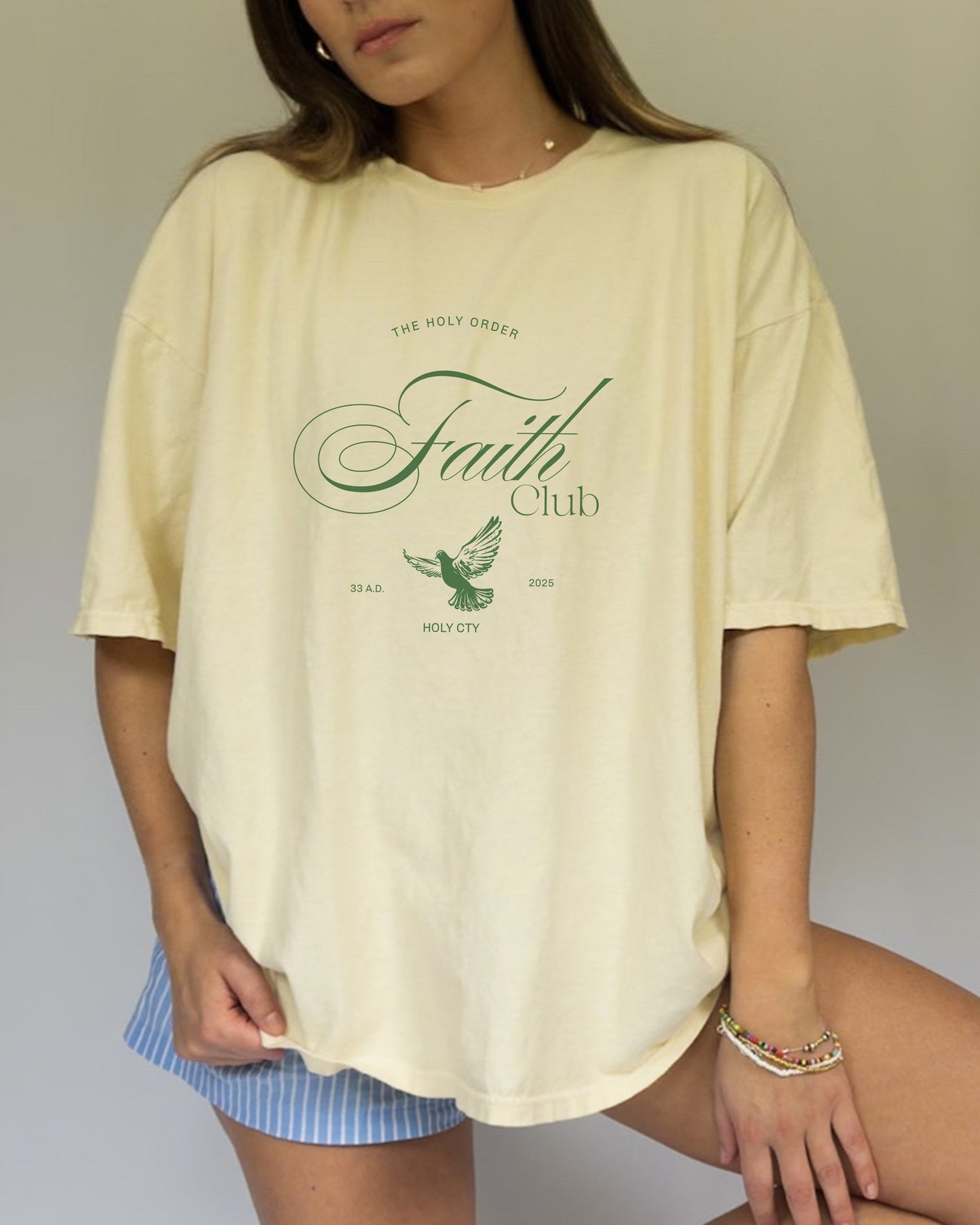 T-shirt with The Holy Order Faith Club text in elegant script with dove design and 33 A.D. Holy City details