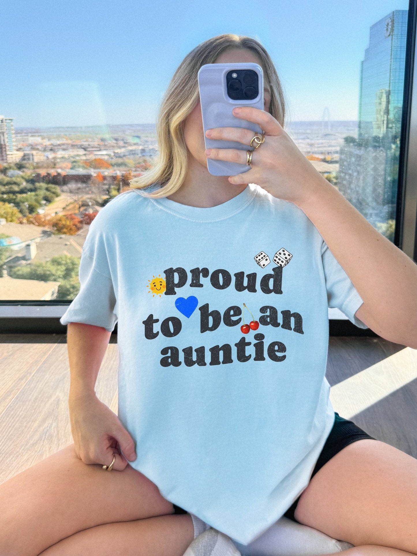 T-shirt with distressed text 'proud to be an auntie' featuring sun, heart, dice and cherries