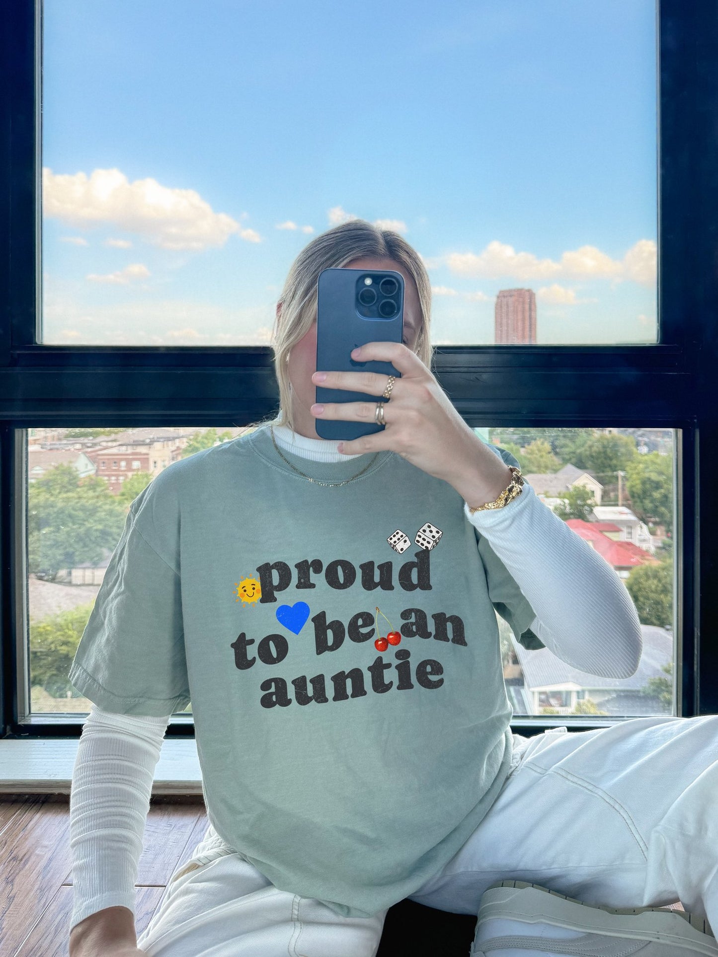 T-shirt with distressed text 'proud to be an auntie' featuring sun, heart, dice and cherries