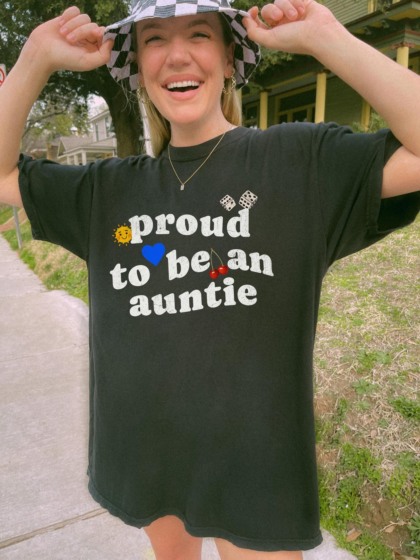 T-shirt with distressed text 'proud to be an auntie' featuring sun, heart, dice and cherries