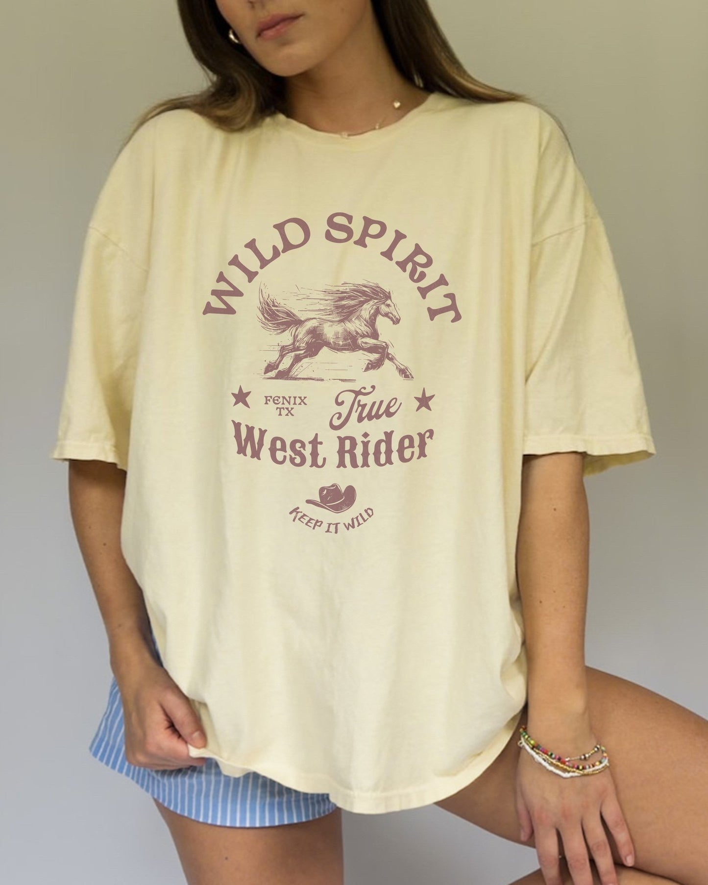 Western t-shirt with galloping horse design, Fenix Texas text, and cowboy hat graphic in vintage style