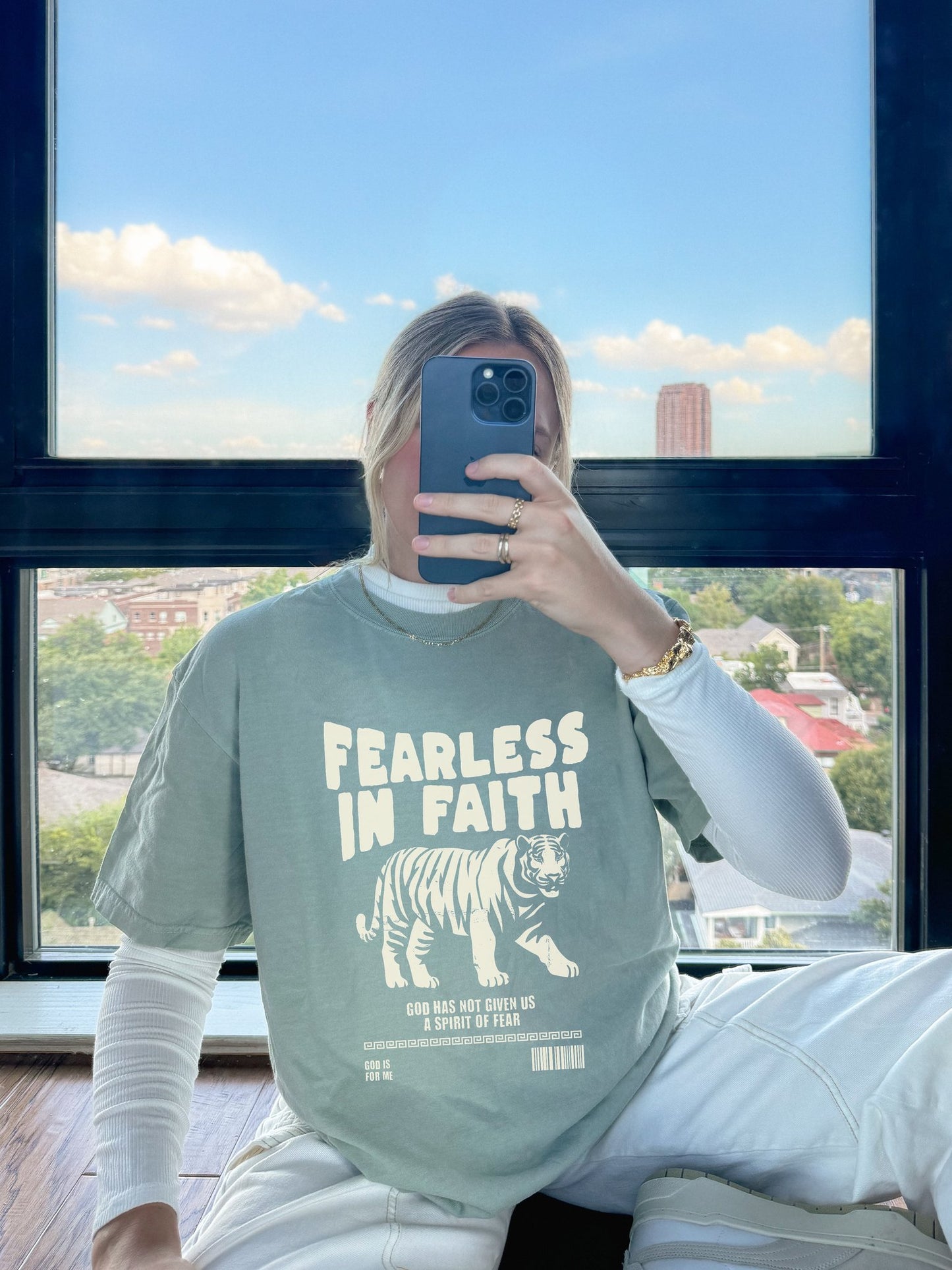 A t-shirt featuring 'Fearless In Faith' text design in elegant cream colored typography