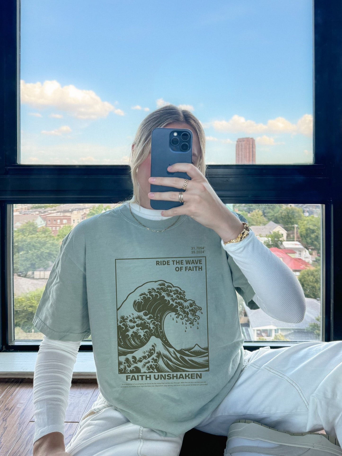 T-shirt with ocean wave design featuring 'Ride The Wave of Faith' and 'Faith Unshaken' text
