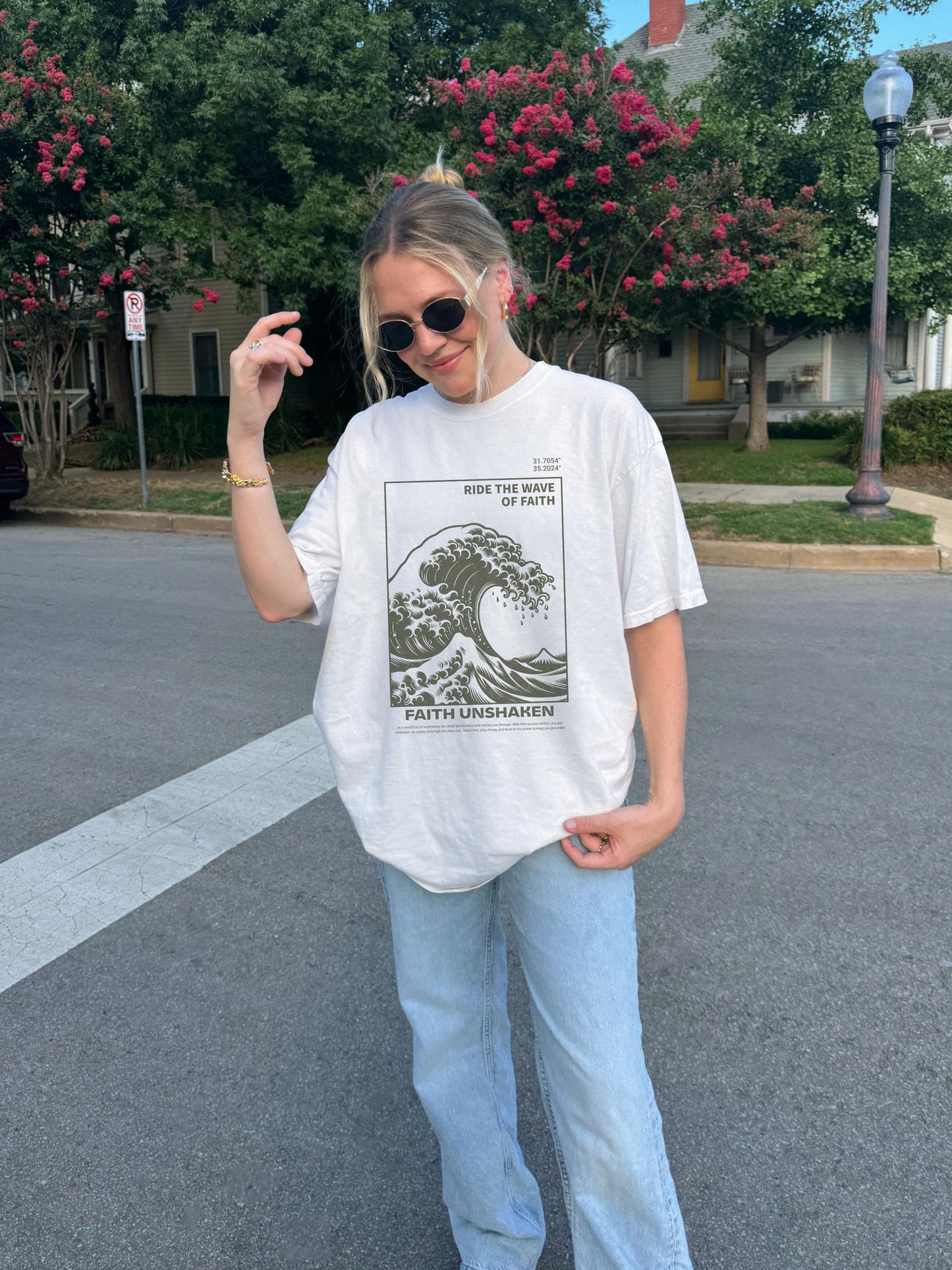 T-shirt with ocean wave design featuring 'Ride The Wave of Faith' and 'Faith Unshaken' text