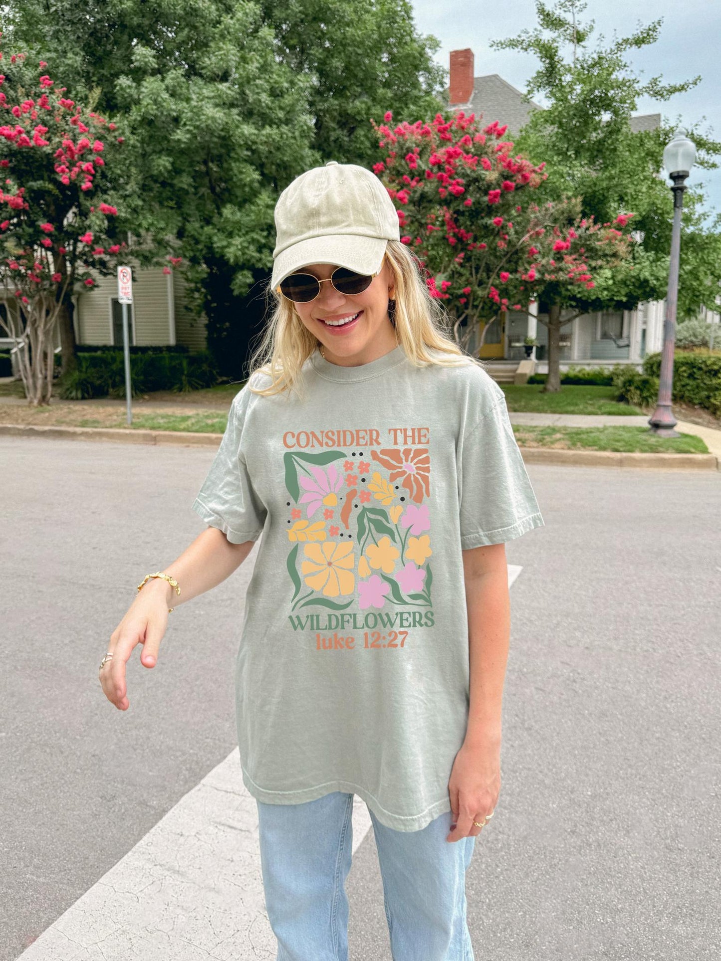 T-shirt with colorful wildflower design and 'Consider the Wildflowers Luke 12:27' bible verse text