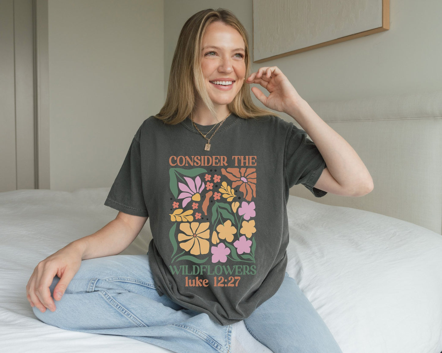 T-shirt with colorful wildflower design and 'Consider the Wildflowers Luke 12:27' bible verse text