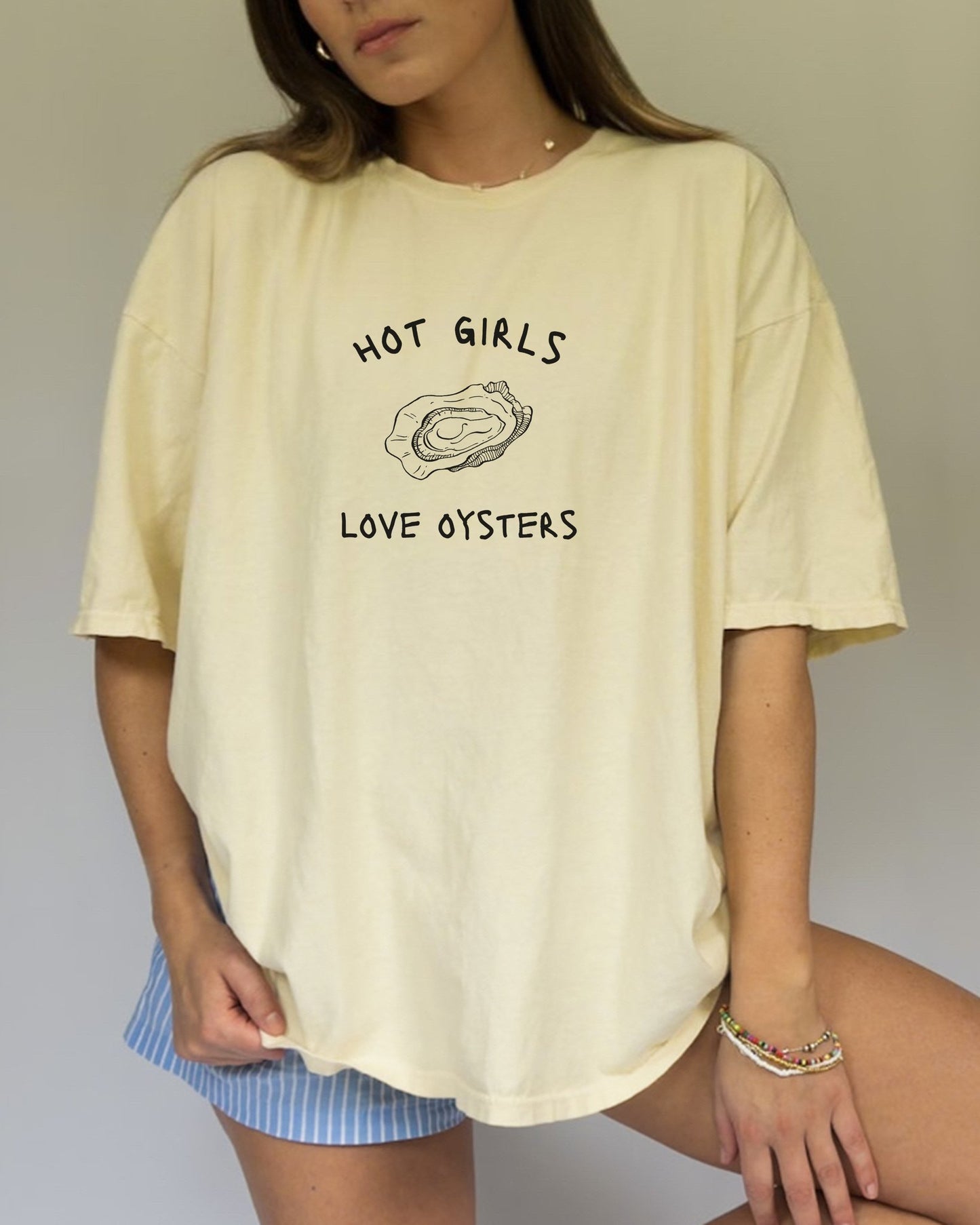 T-shirt with 'Hot Girls Love Oysters' text and hand-drawn black oyster shell illustration