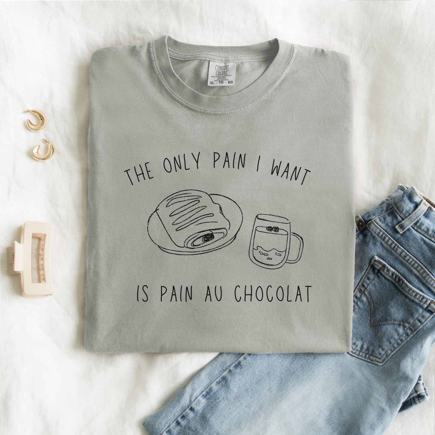 T-shirt with hand-drawn croissant and coffee cup illustration and funny baking text
