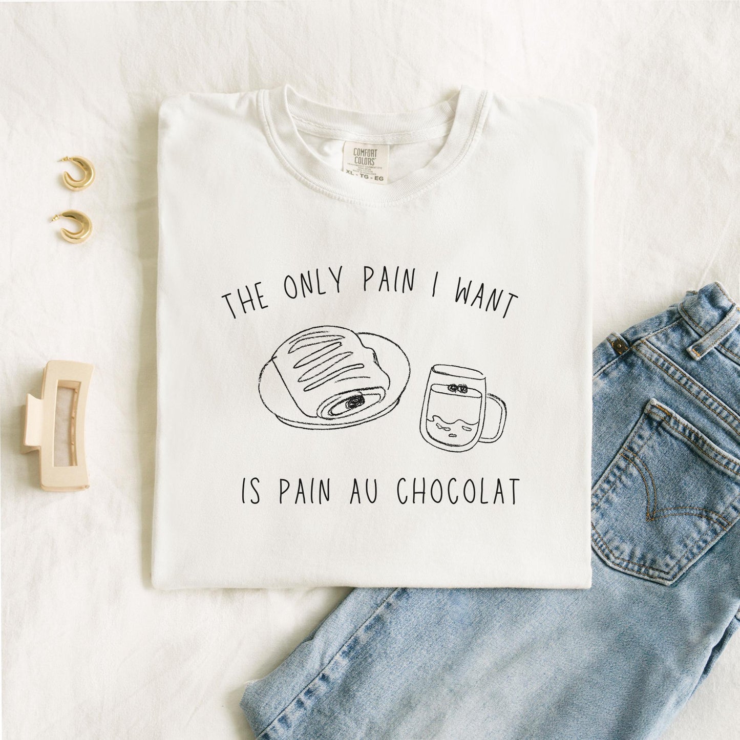 T-shirt with hand-drawn croissant and coffee cup illustration and funny baking text