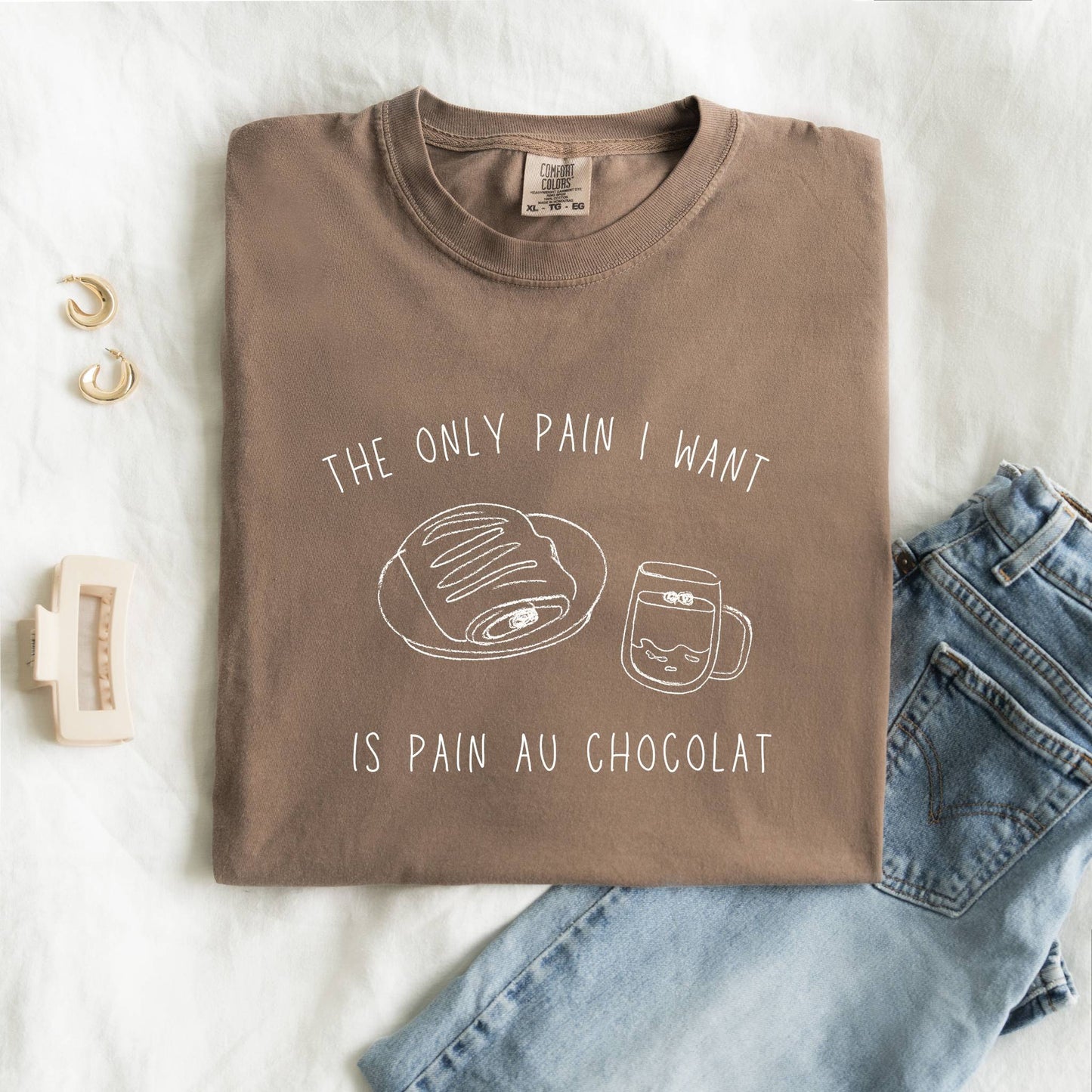 T-shirt with hand-drawn croissant and coffee cup illustration and funny baking text