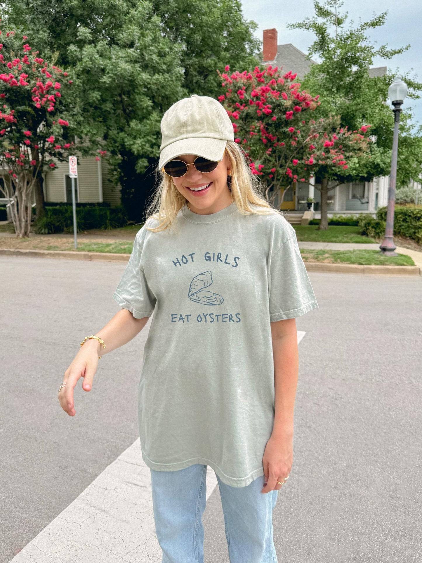 T-shirt with 'Hot Girls Eat Oysters' text and minimalist oyster shell illustration in blue tones
