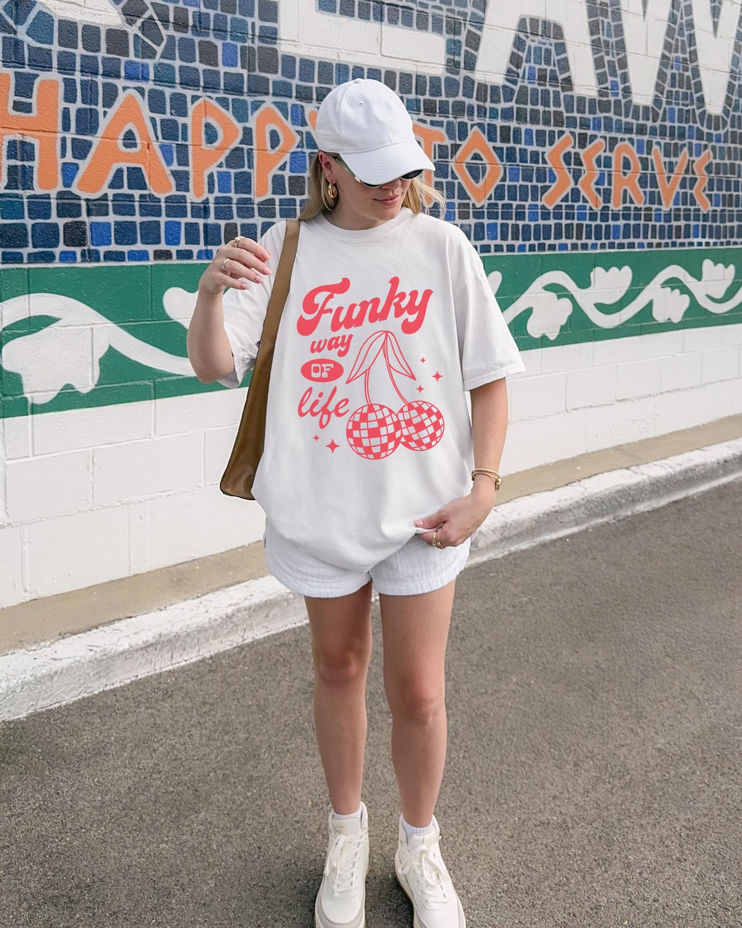T-shirt with red retro cherry design featuring checkered disco ball cherries and funky typography