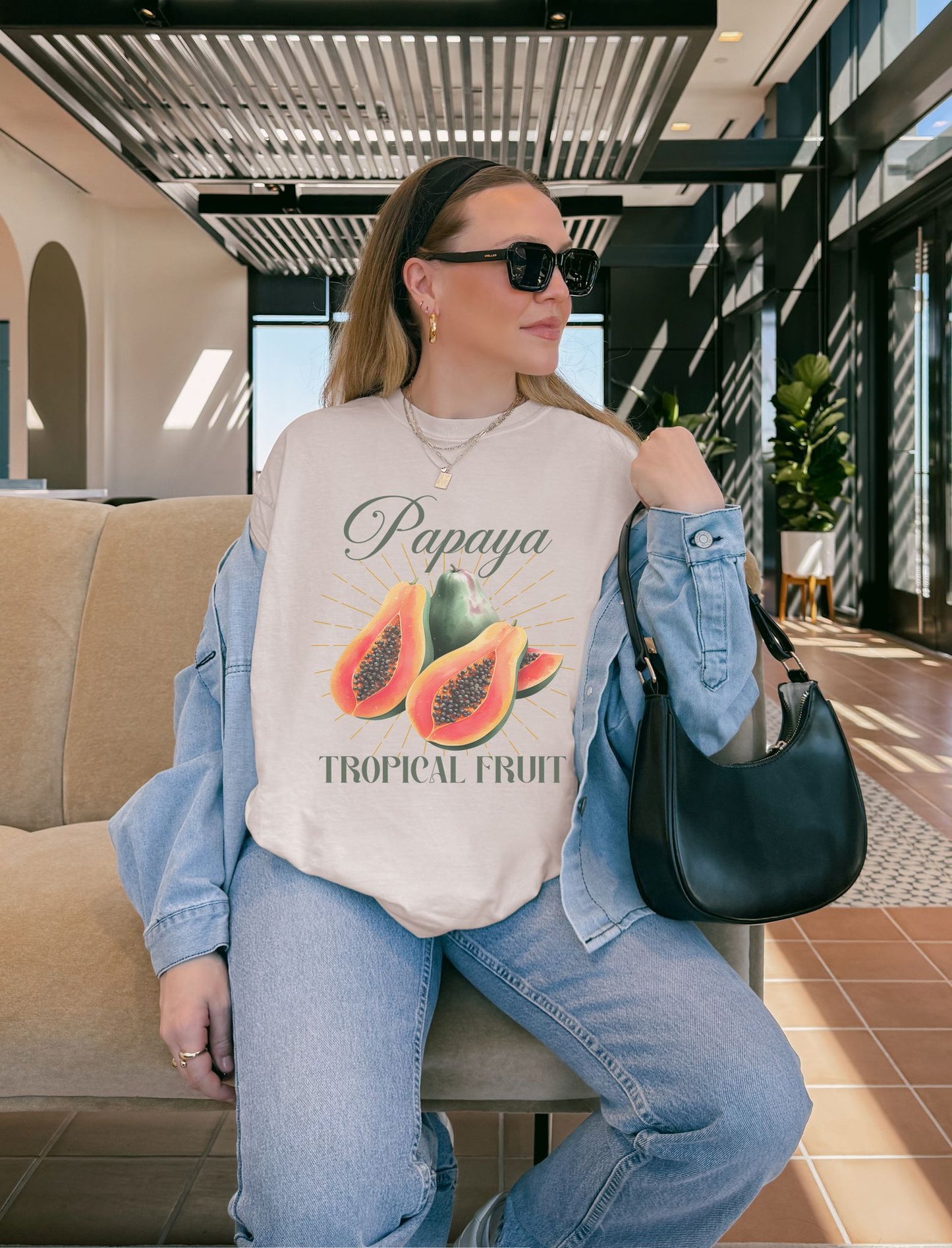 T-shirt featuring watercolor papaya fruits with golden sunburst rays and elegant Papaya script text