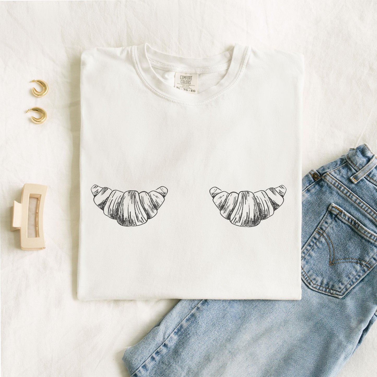 T-shirt with black and white hand-drawn croissant illustrations in vintage sketch style