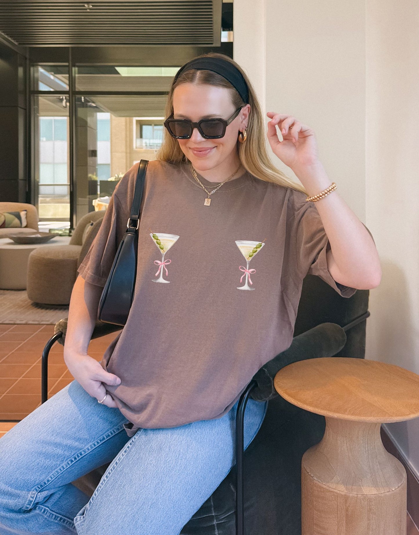 T-shirt design with two martini glasses containing olives and pink bow details creating a humorous cocktail theme