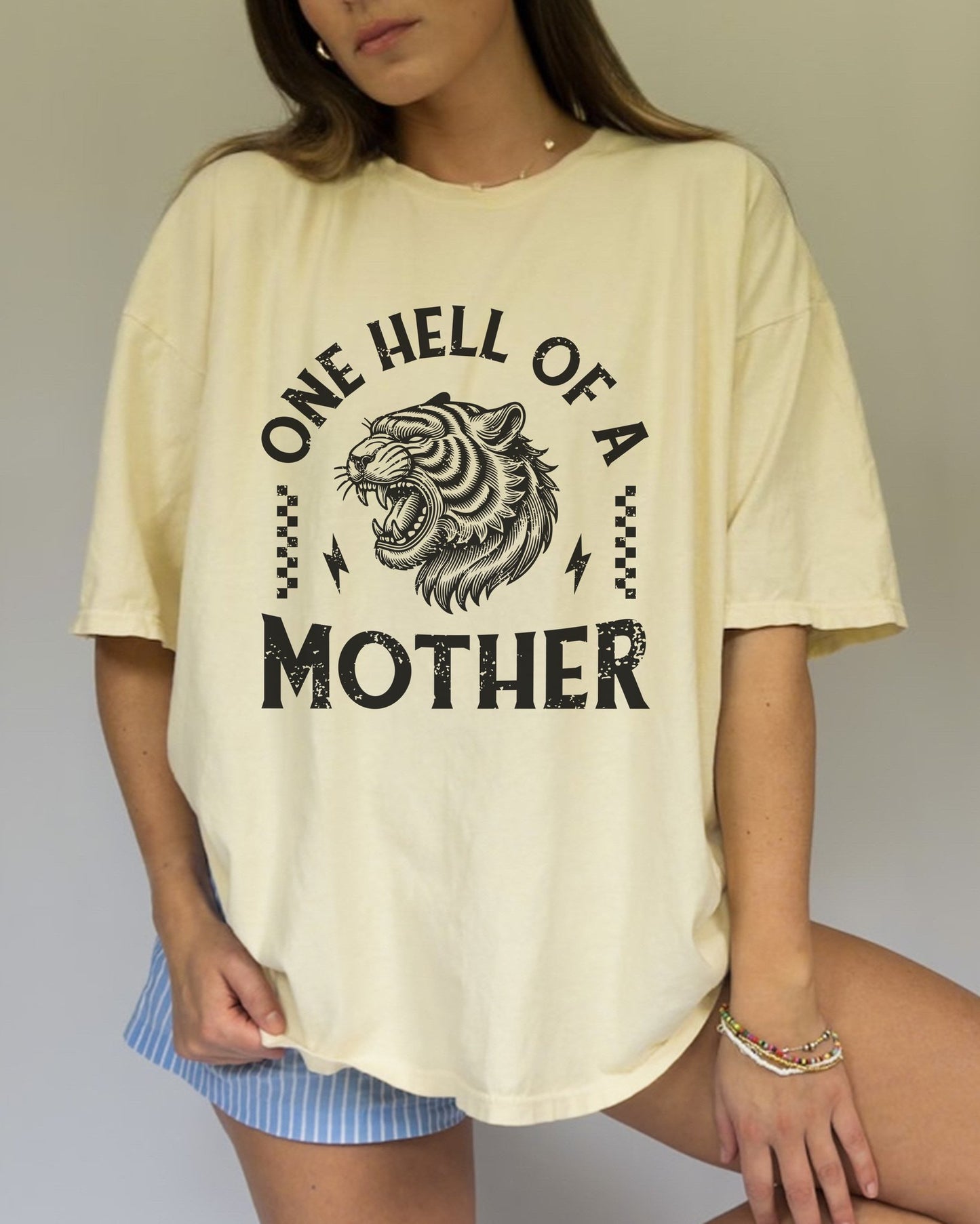 Black and white t-shirt with roaring tiger head and 'One Hell Of A Mother' text in distressed lettering