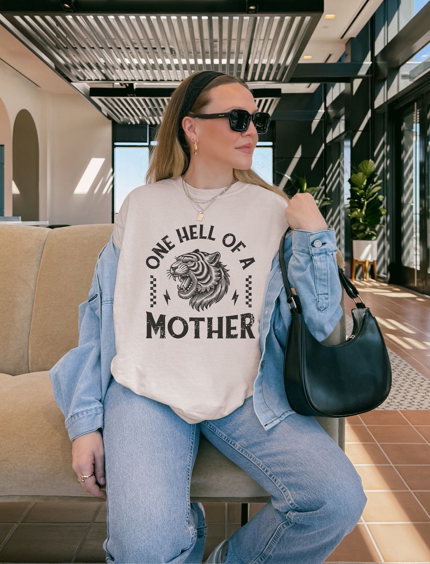 Black and white t-shirt with roaring tiger head and 'One Hell Of A Mother' text in distressed lettering