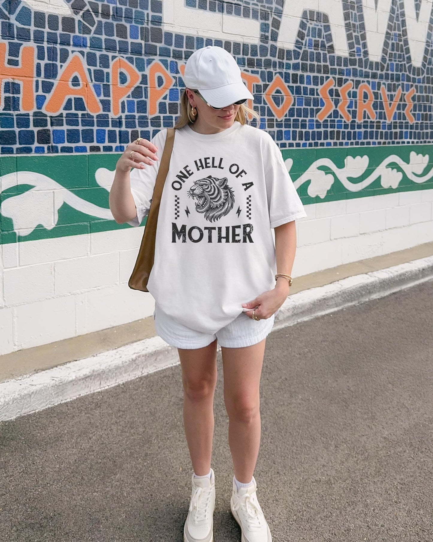 Black and white t-shirt with roaring tiger head and 'One Hell Of A Mother' text in distressed lettering