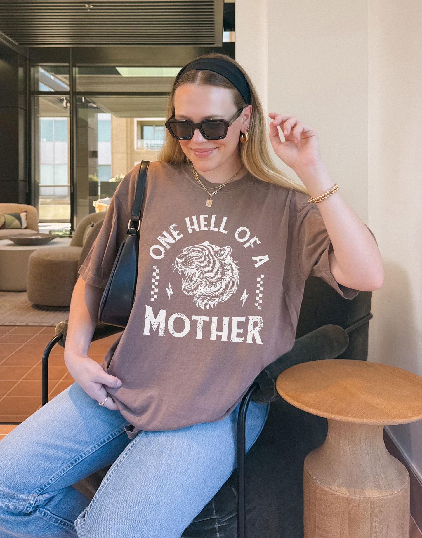 Black and white t-shirt with roaring tiger head and 'One Hell Of A Mother' text in distressed lettering