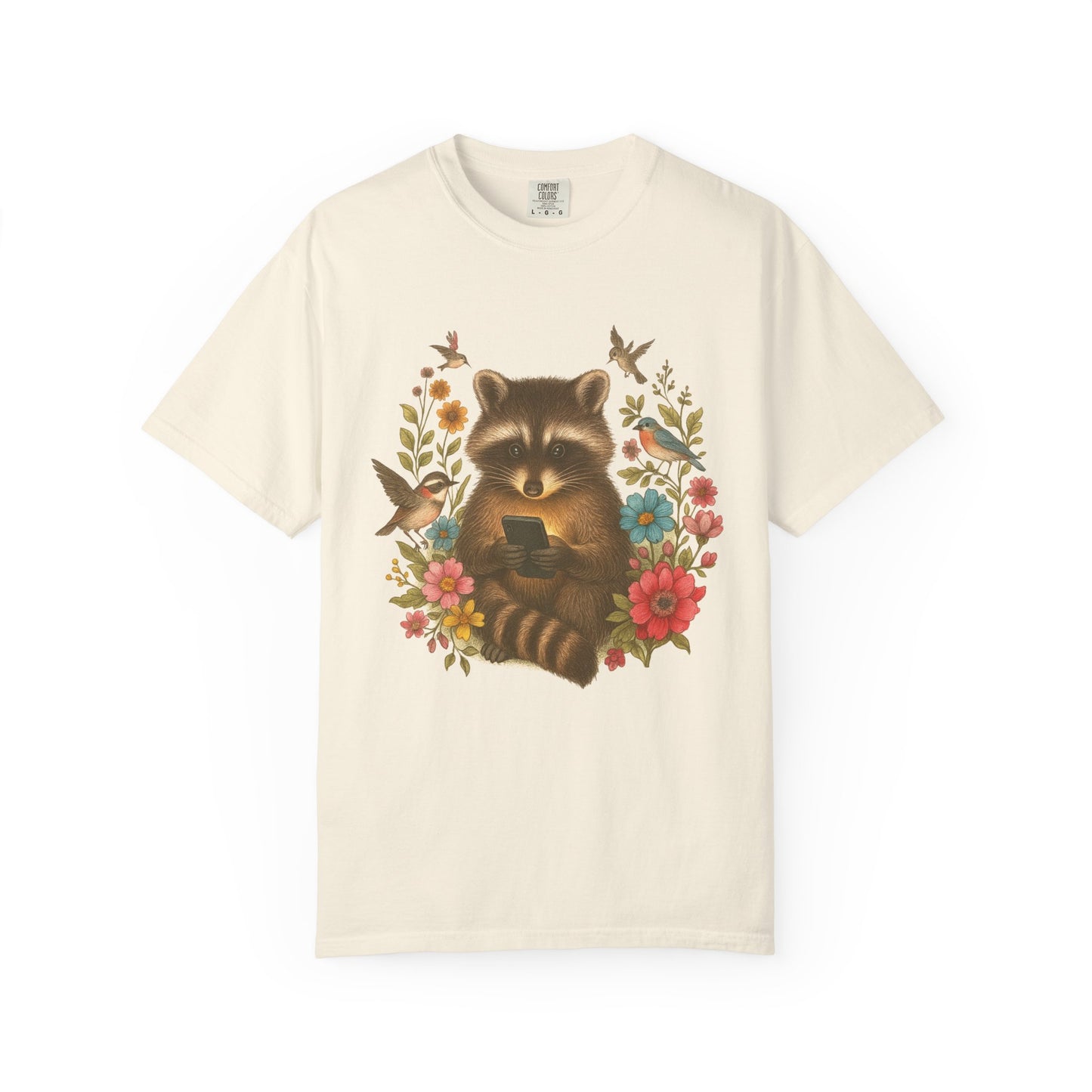 T-shirt design showing raccoon holding phone surrounded by colorful wildflowers and birds