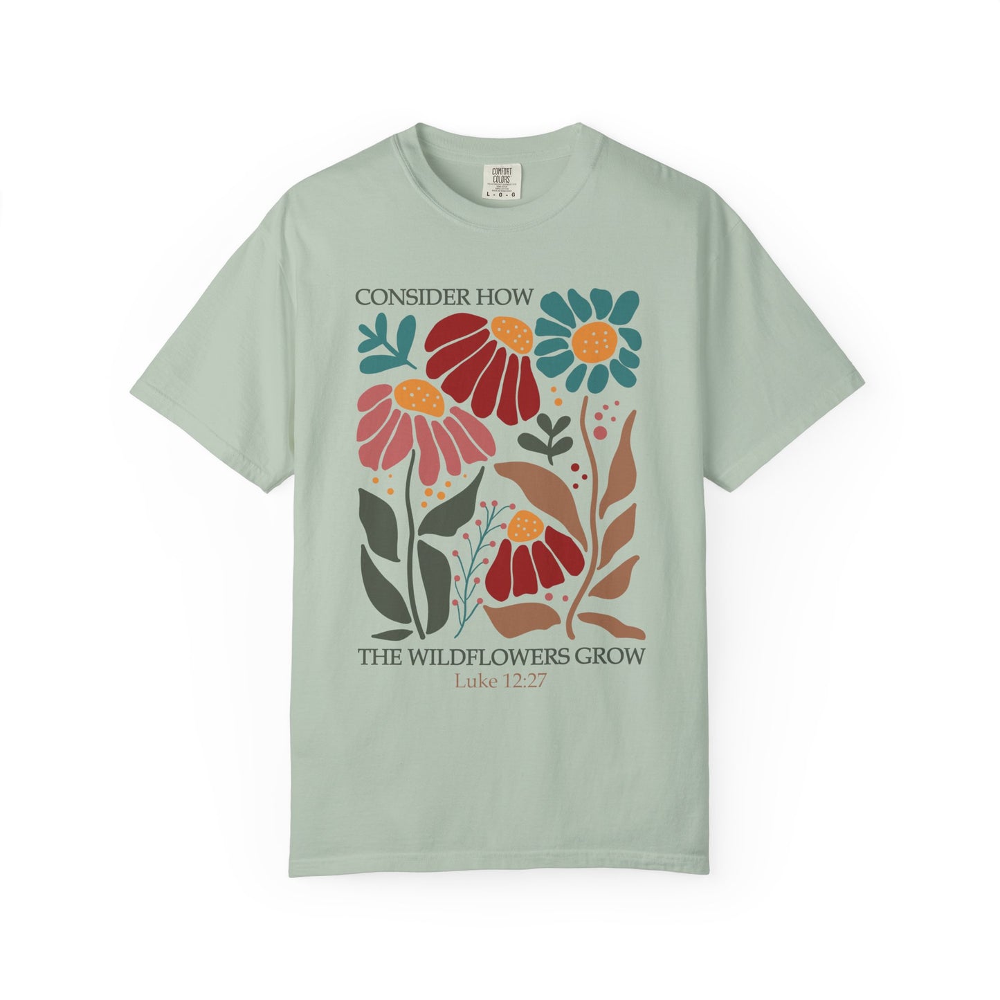 T-shirt with Luke 12:27 Bible verse and colorful wildflowers in red, pink, teal, and brown tones