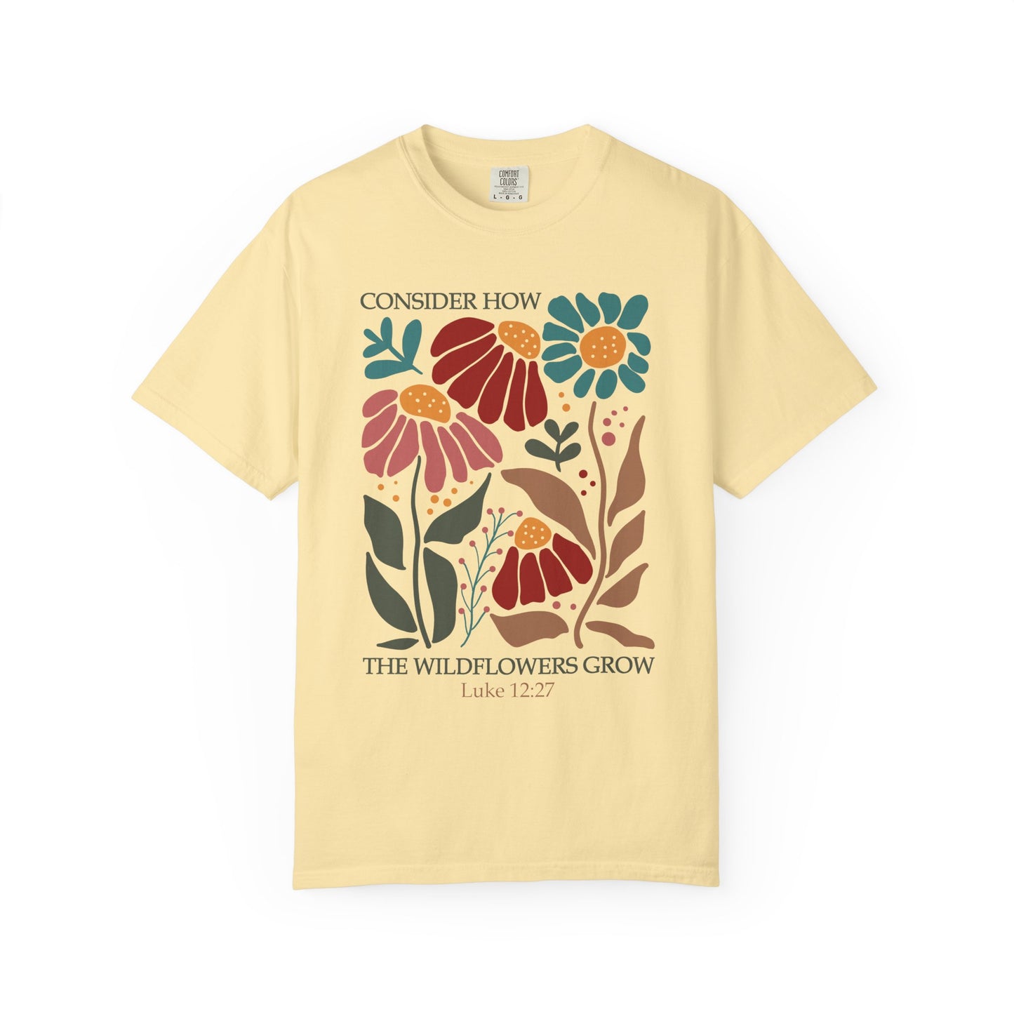 T-shirt with Luke 12:27 Bible verse and colorful wildflowers in red, pink, teal, and brown tones