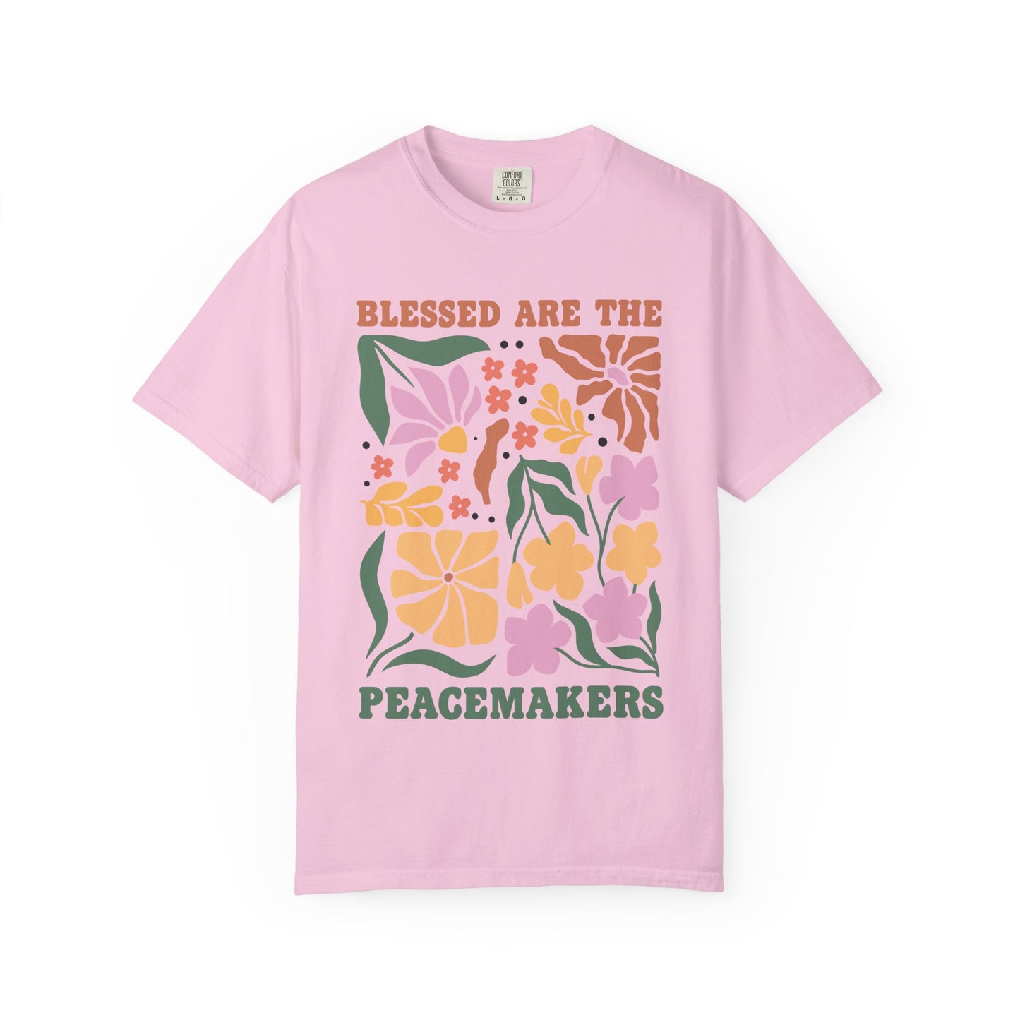 T-shirt with 'Blessed Are The Peacemakers' text surrounded by colorful floral design in pink, coral, yellow and green