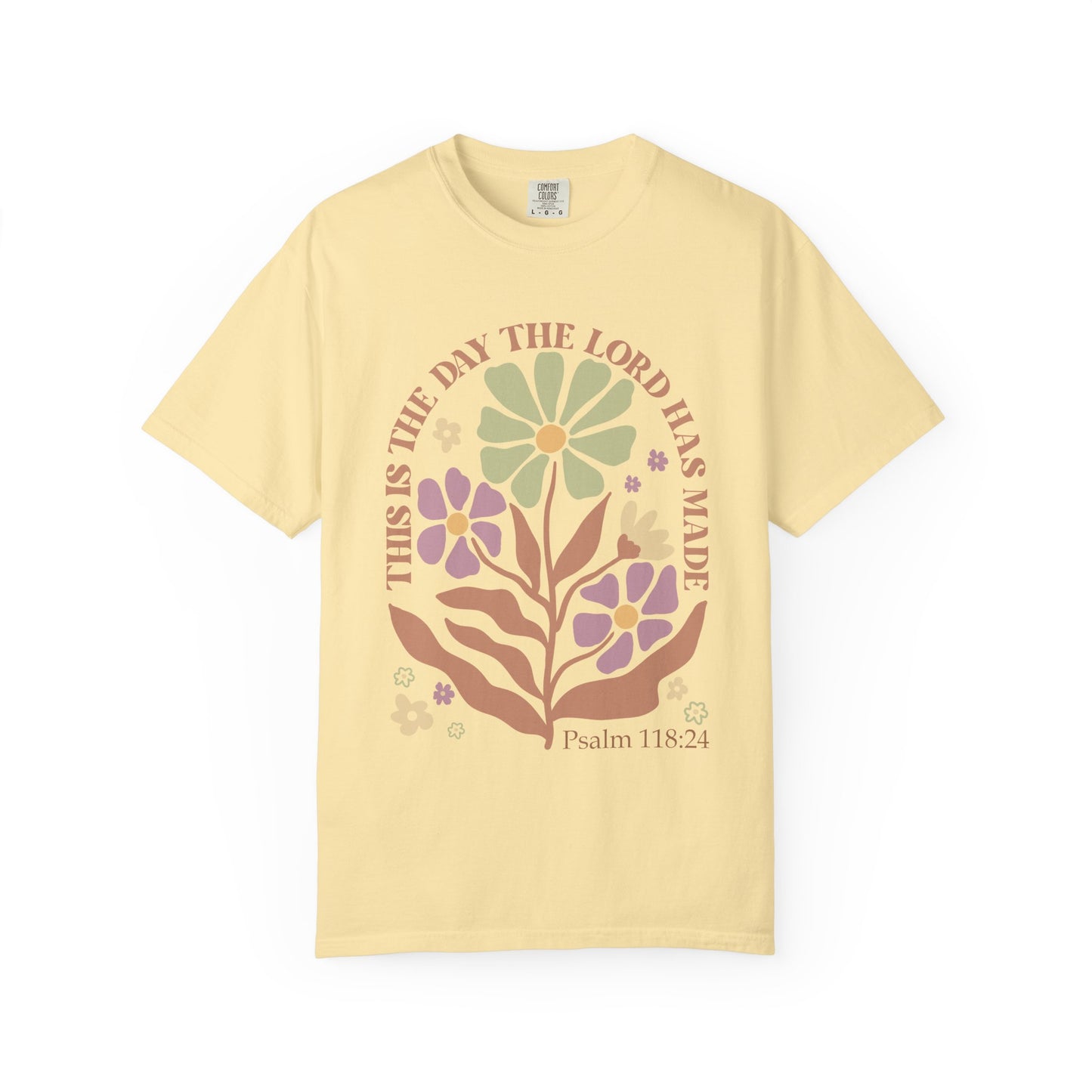T-shirt with 'This is the Day' text, Psalm 118:24 verse, and floral design with protective hands in sage green, pink, and terracotta colors