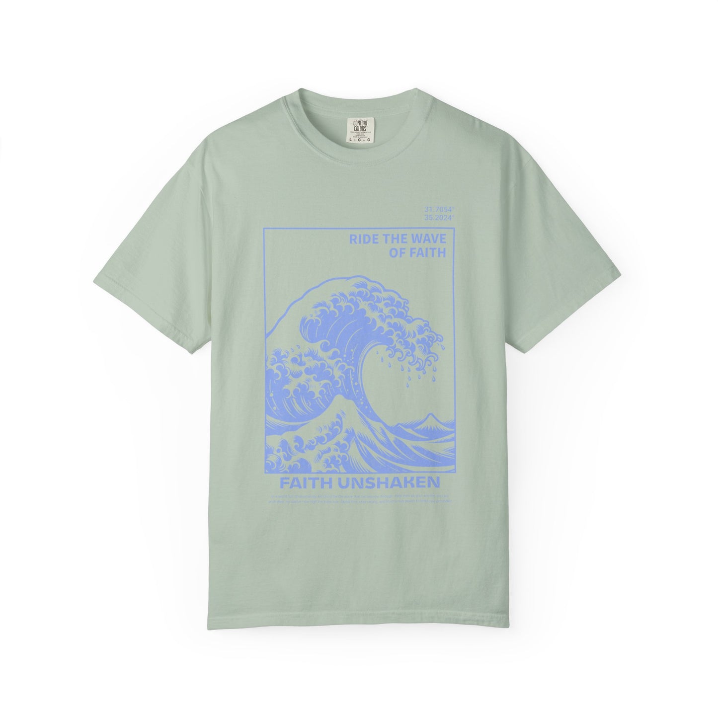 T-shirt with blue ocean wave design featuring 'Ride The Wave Of Faith' and 'Faith Unshaken' text