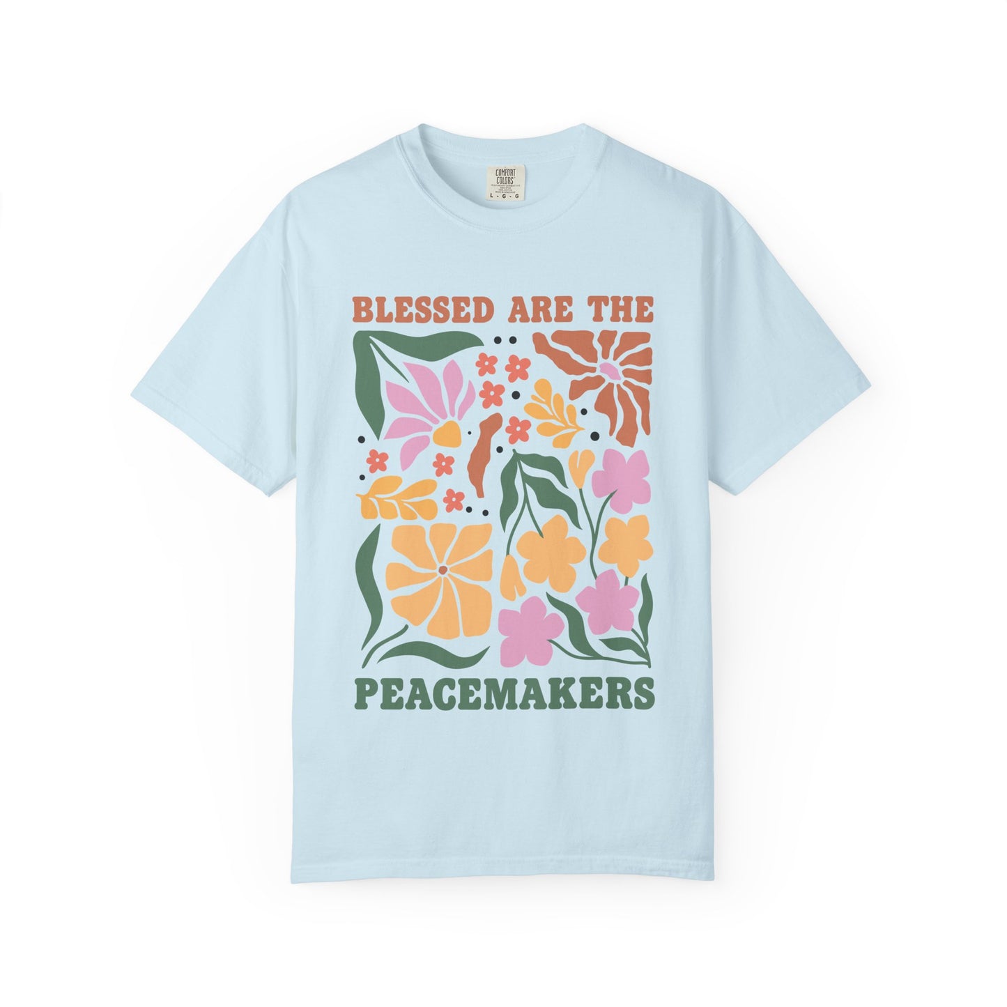 T-shirt with 'Blessed Are The Peacemakers' text surrounded by colorful floral design in pink, coral, yellow and green