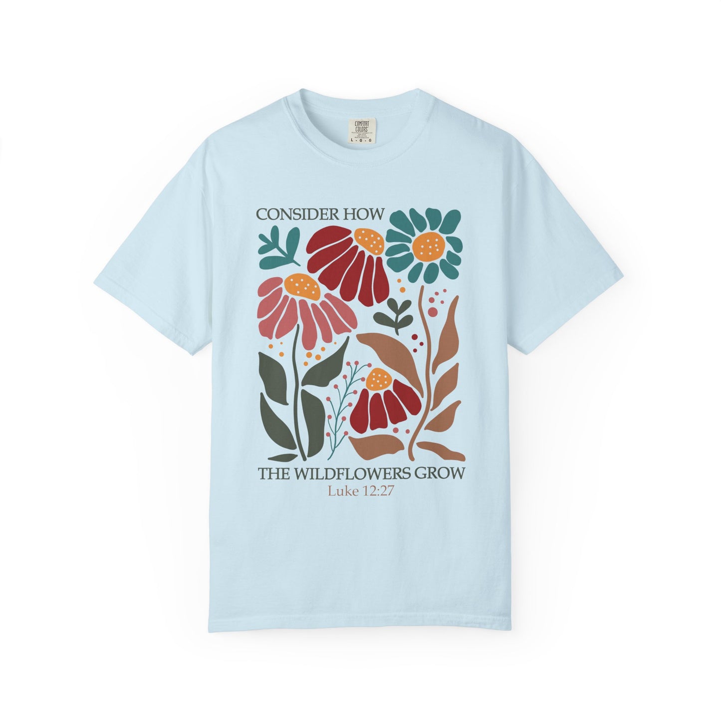 T-shirt with Luke 12:27 Bible verse and colorful wildflowers in red, pink, teal, and brown tones
